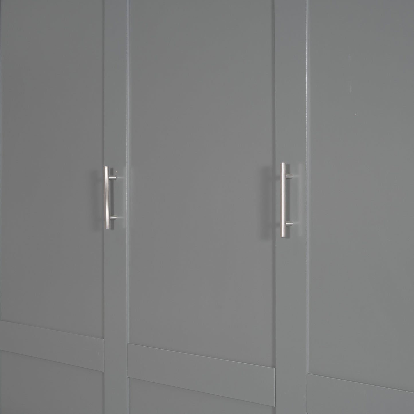 Closeup of a gray wardrobe door with a brushed nickel handle