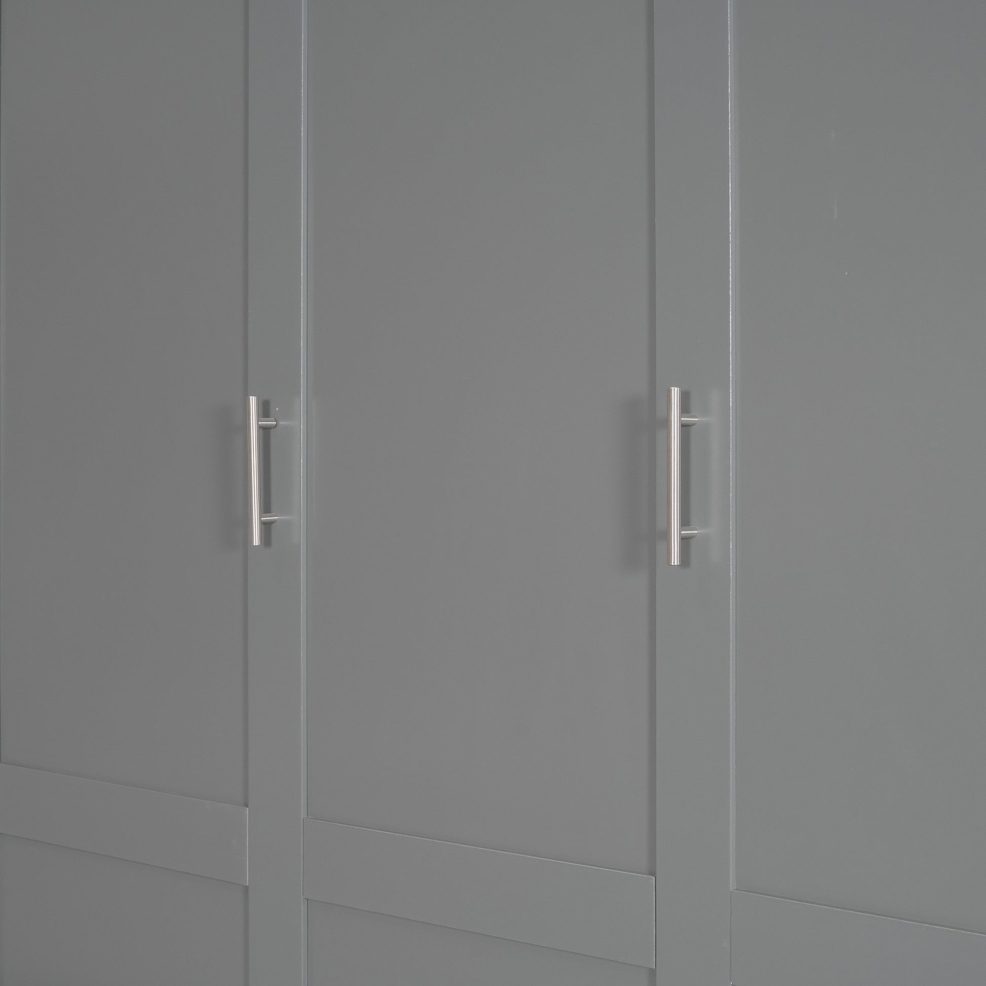 Closeup of a gray wardrobe door with a brushed nickel handle