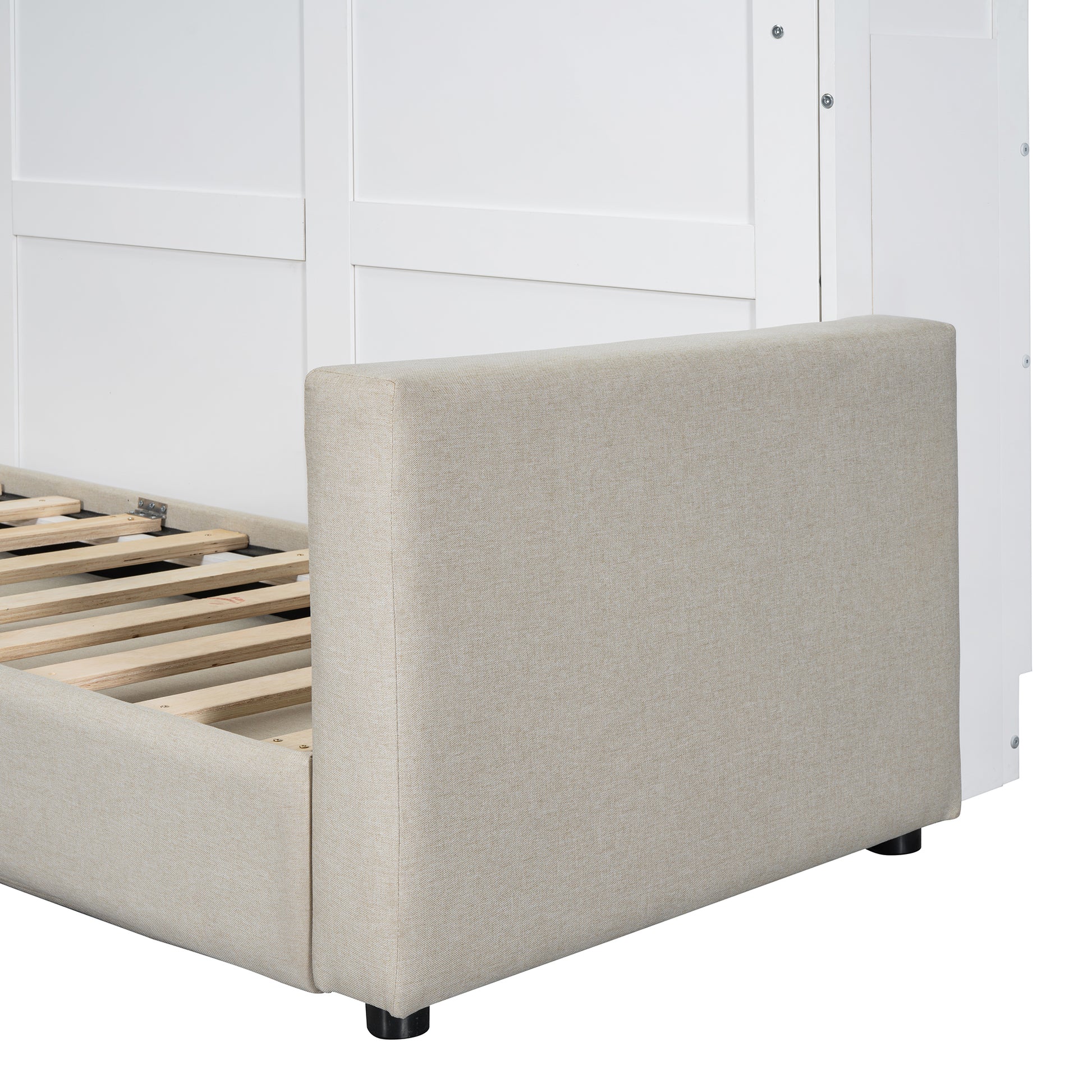 Beige upholstered headboard with white paneling and wooden bed frame