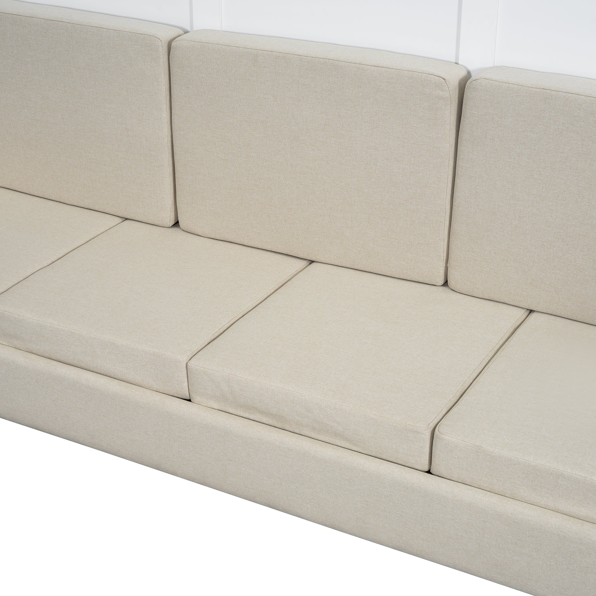 Closeup of a beige linen sofa with plush cushions