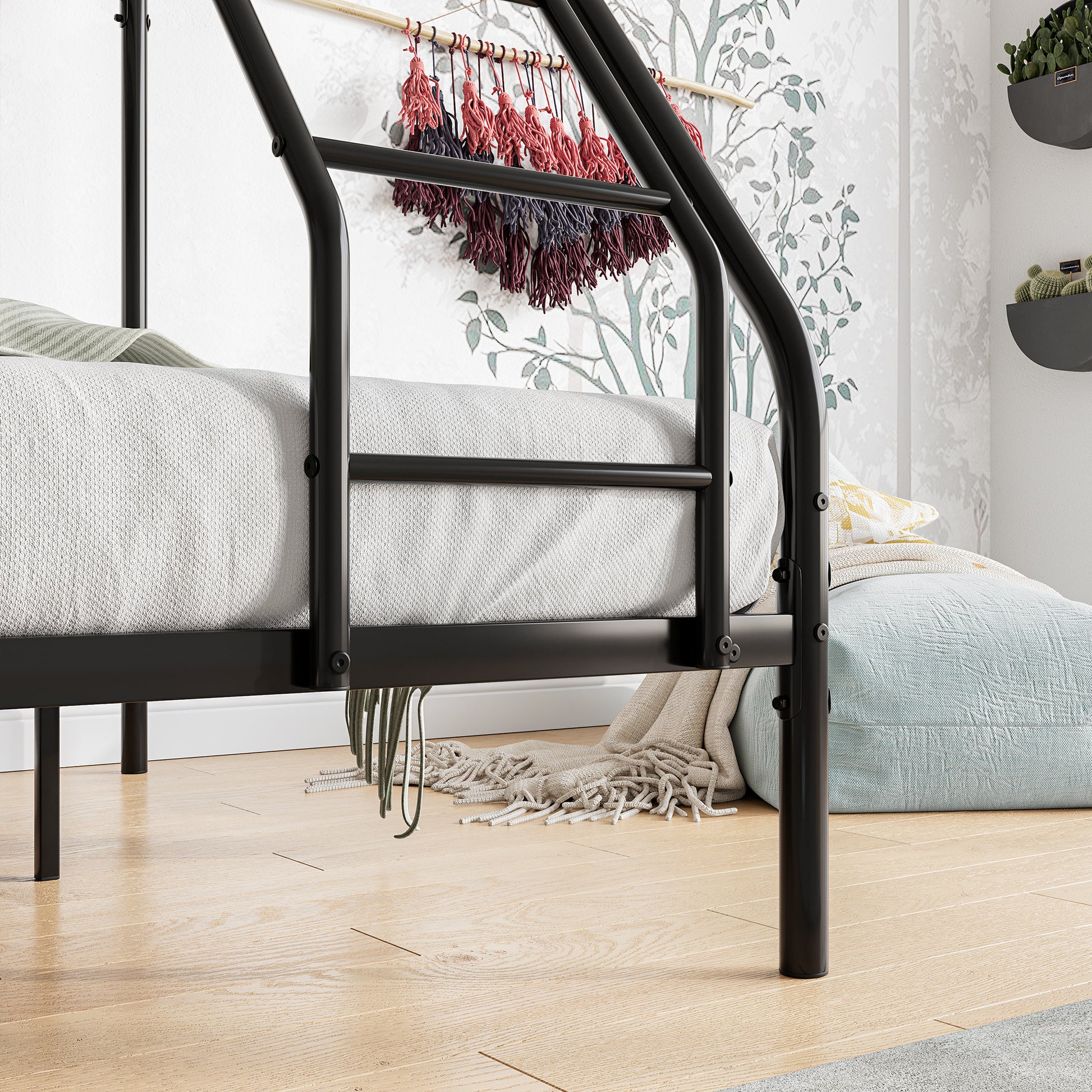 Black metal bed frame with white bedding and green accent pillow