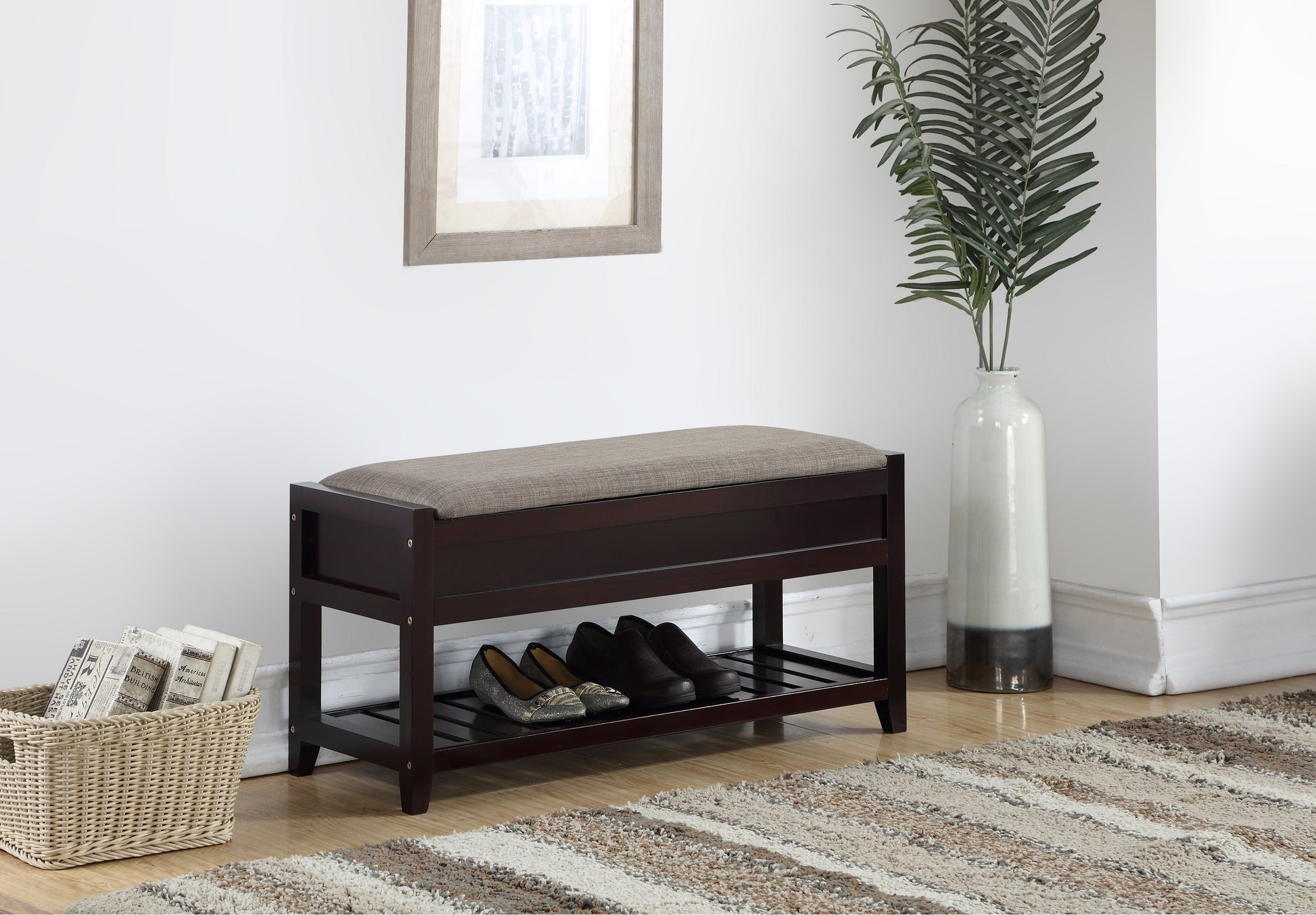 Dark brown storage bench with cushioned top and two shelves storing shoes