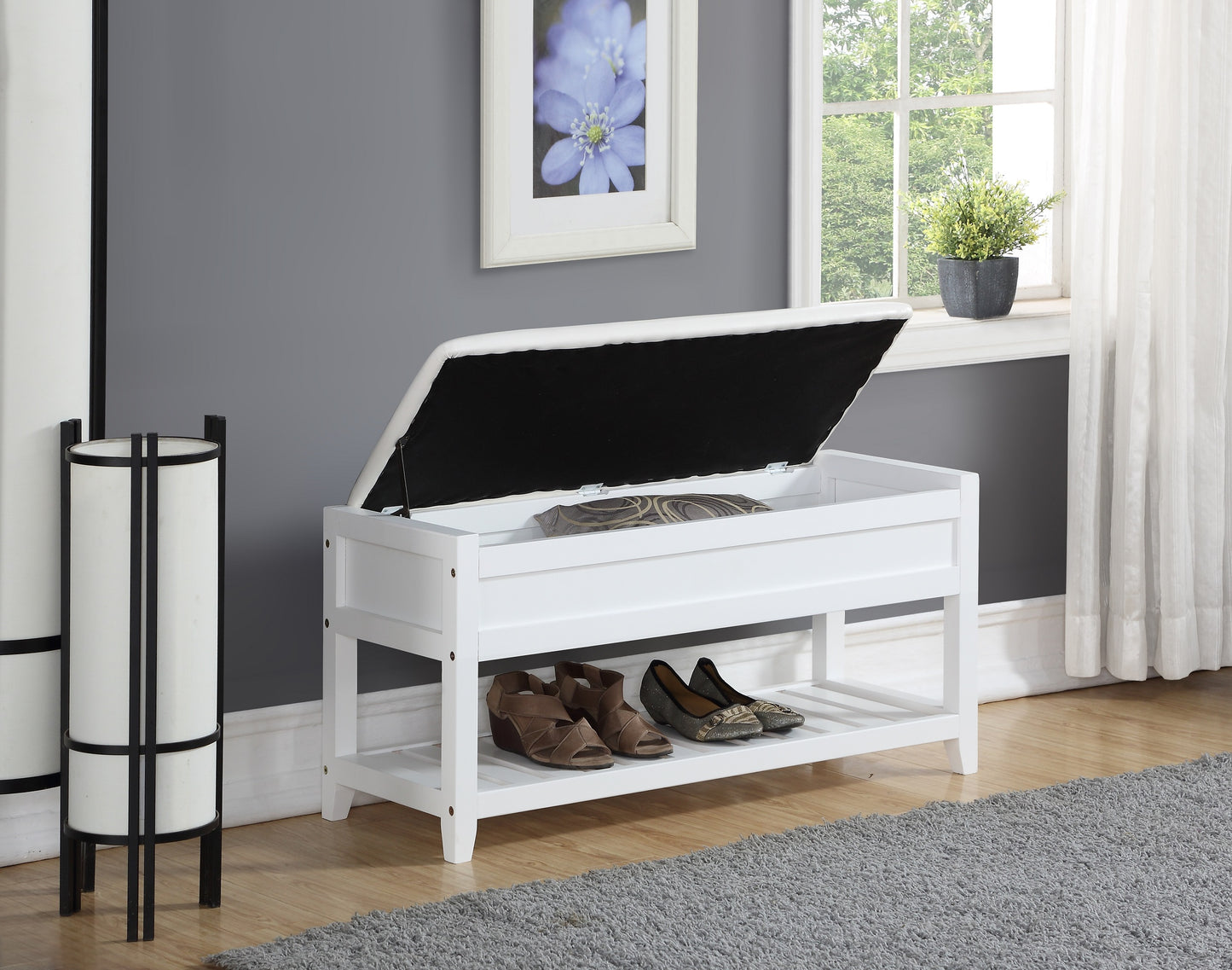 White storage bench with two shelves holding shoes