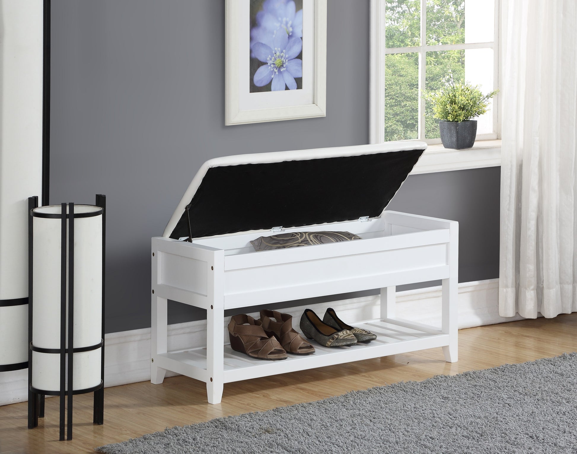 White storage bench with two shelves holding shoes
