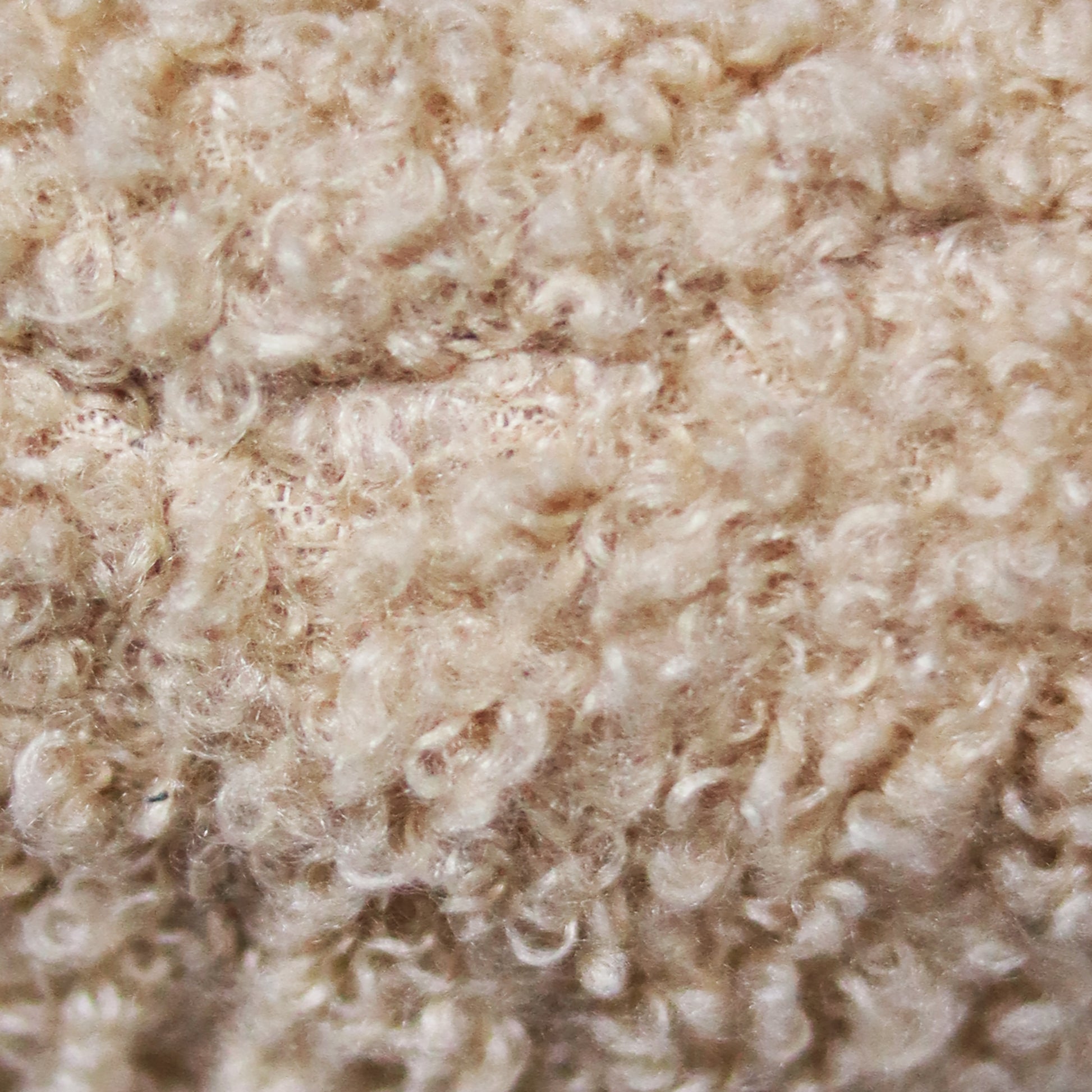 Creamy beige textured wool fabric with visible loops ideal for cozy knitwear