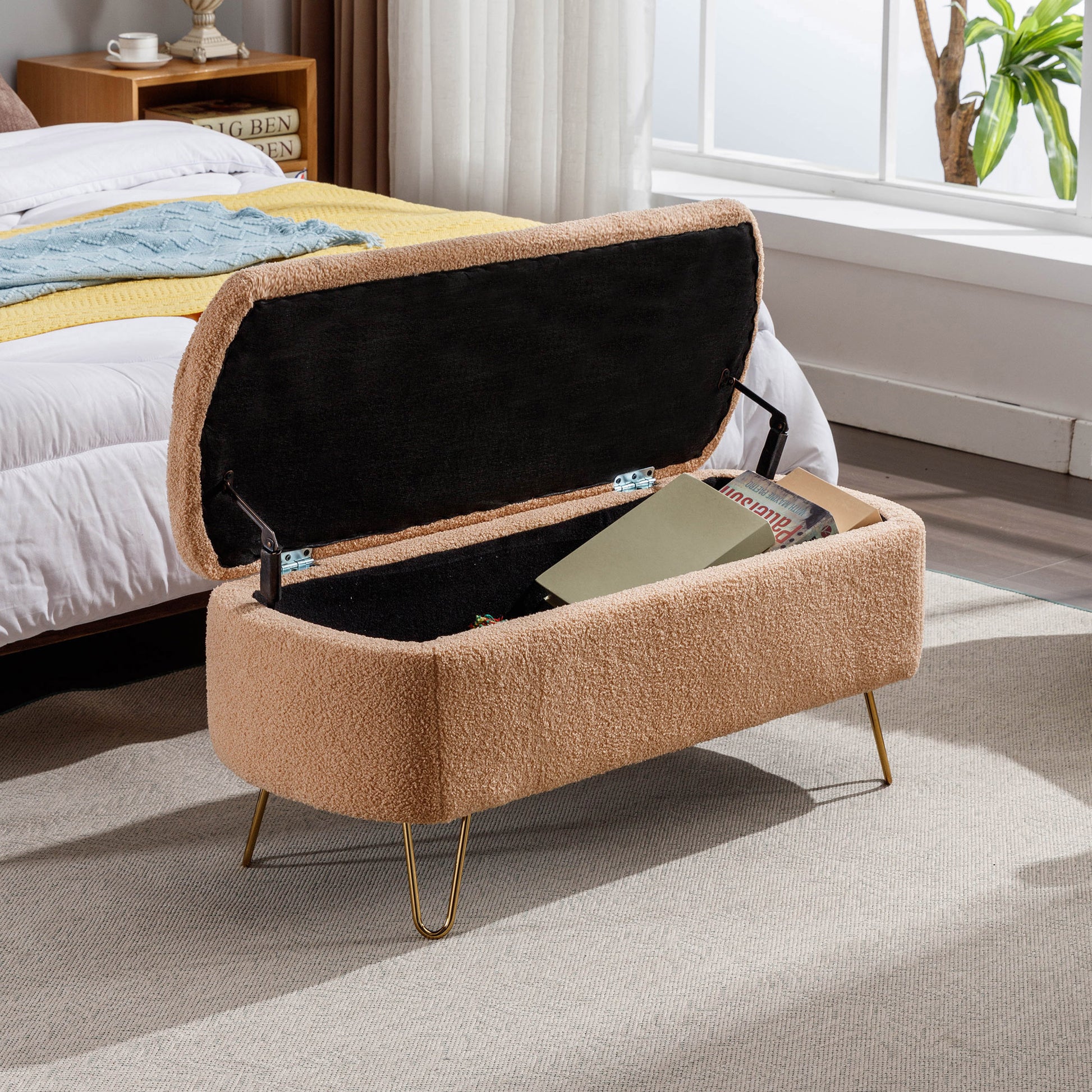 Tan boucl storage ottoman with open lid and gold hairpin legs