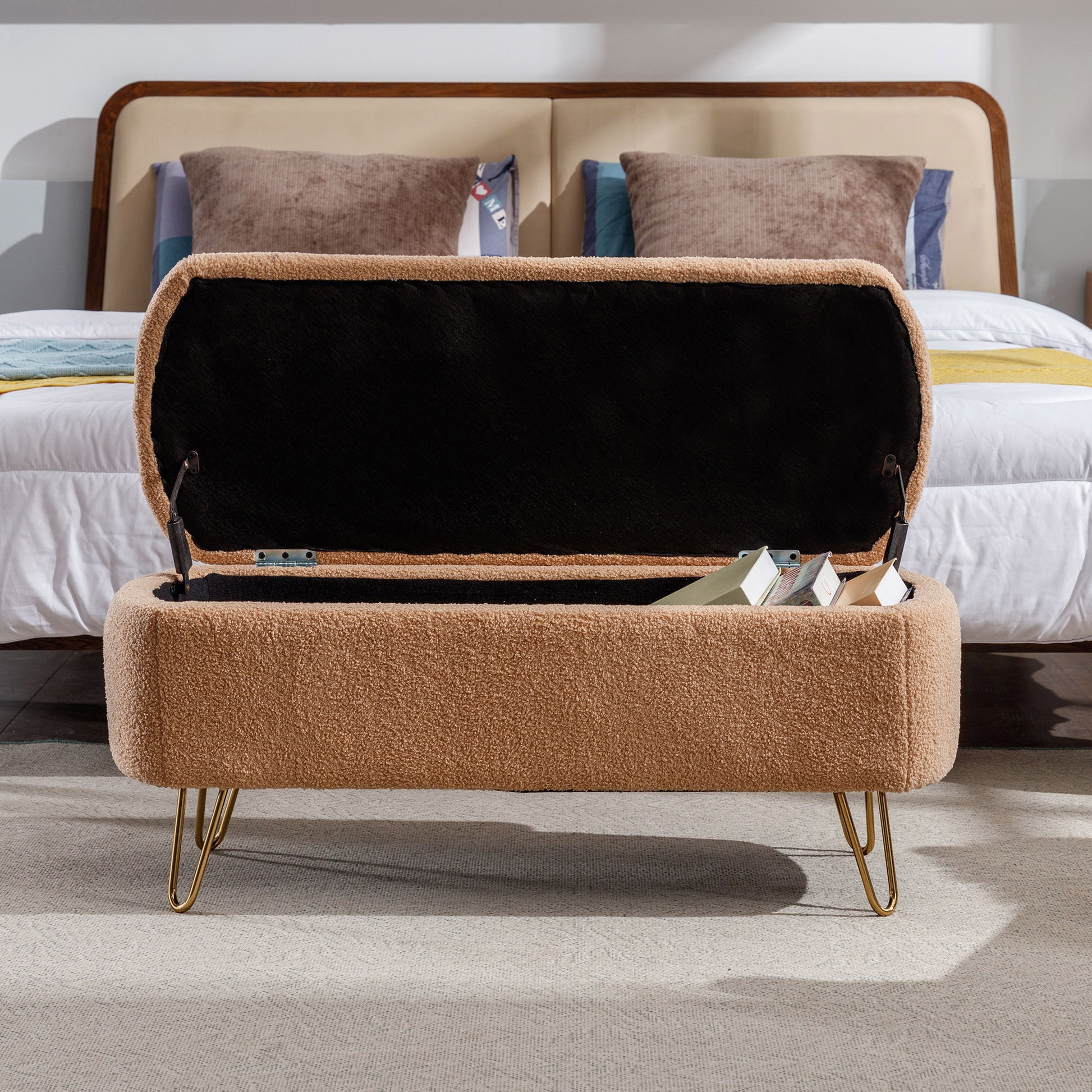Open tan boucle storage ottoman with gold hairpin legs perfect for bedroom entryways