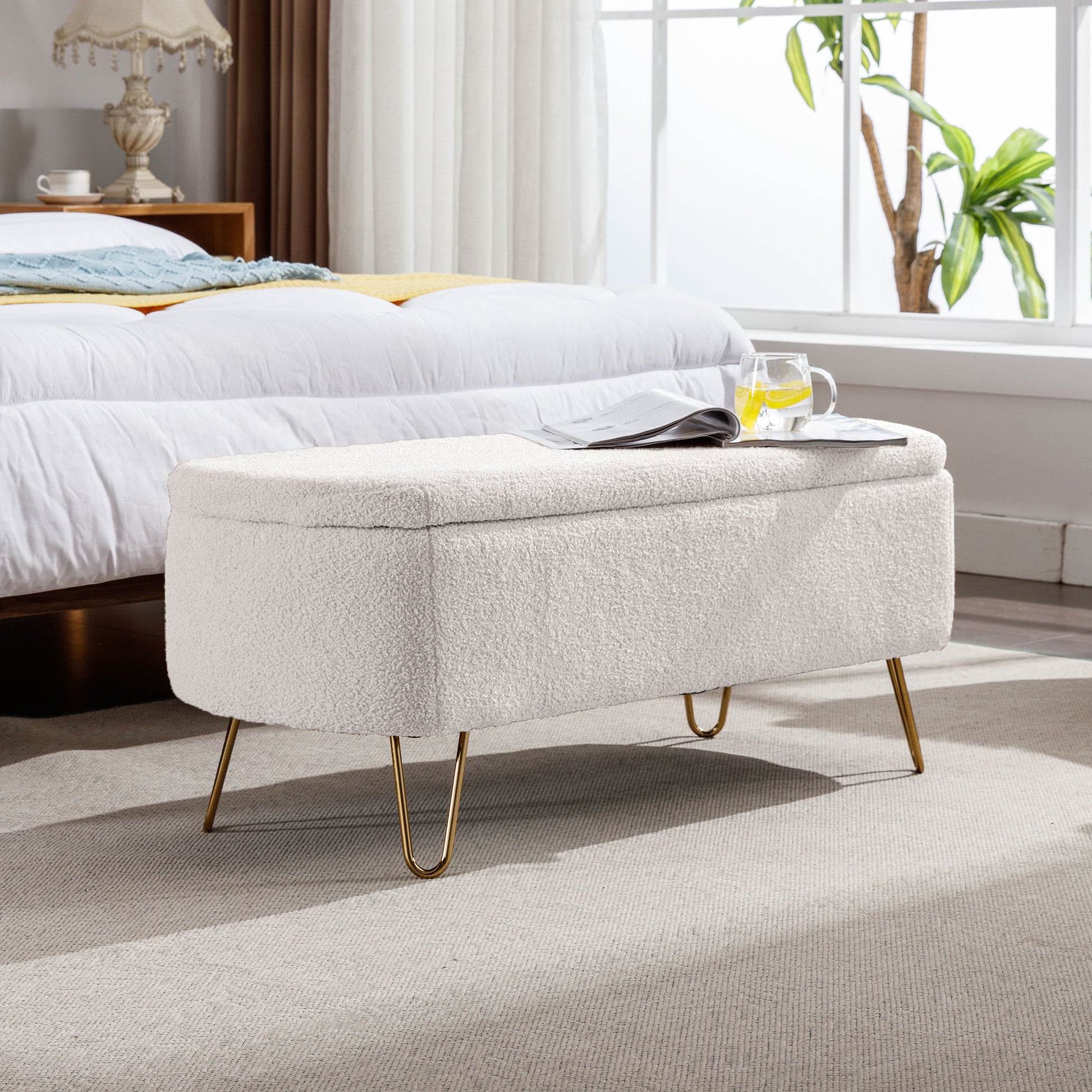Cream boucle storage ottoman with gold hairpin legs