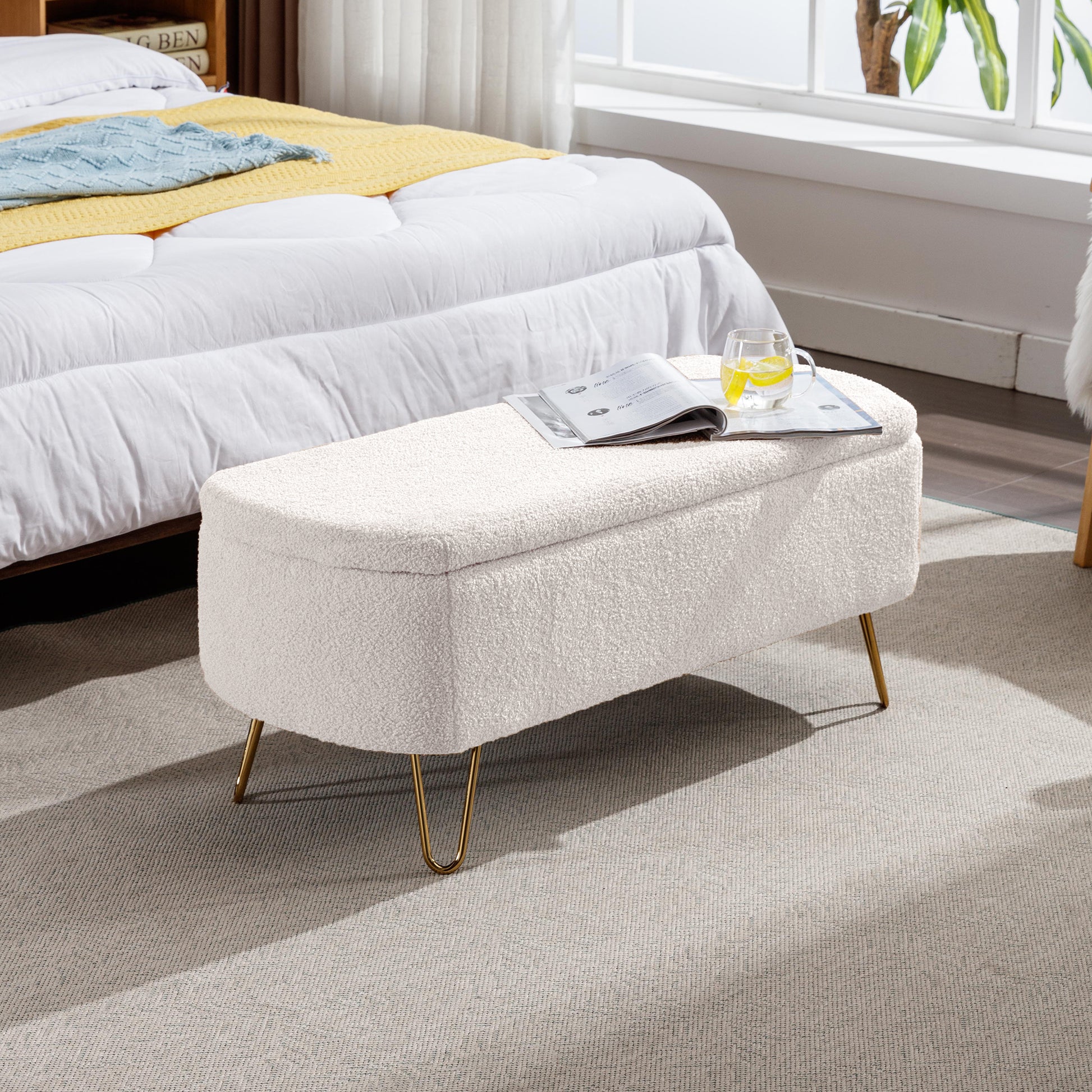 Cream boucle storage ottoman with gold hairpin legs