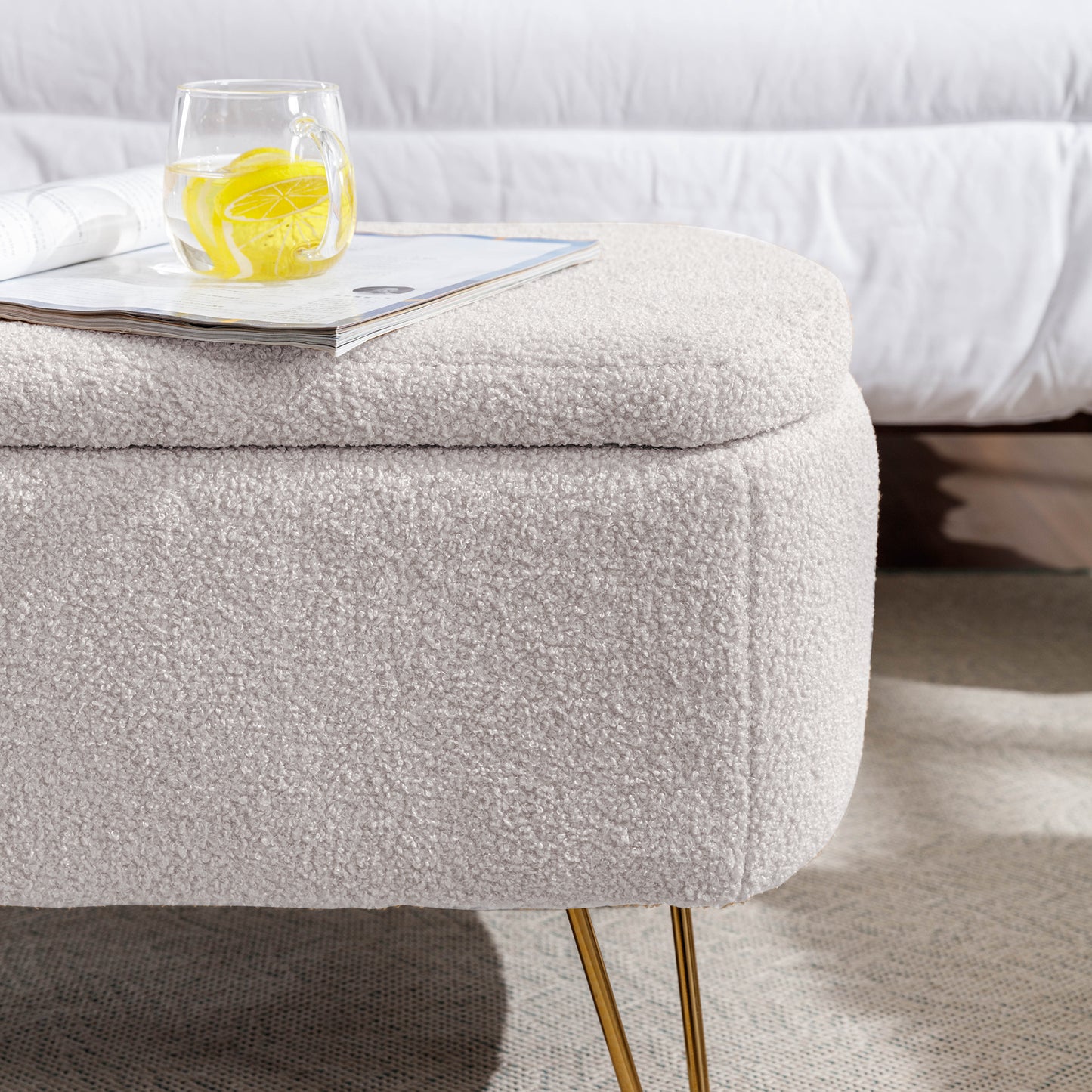 Cream boucle storage ottoman with gold hairpin legs