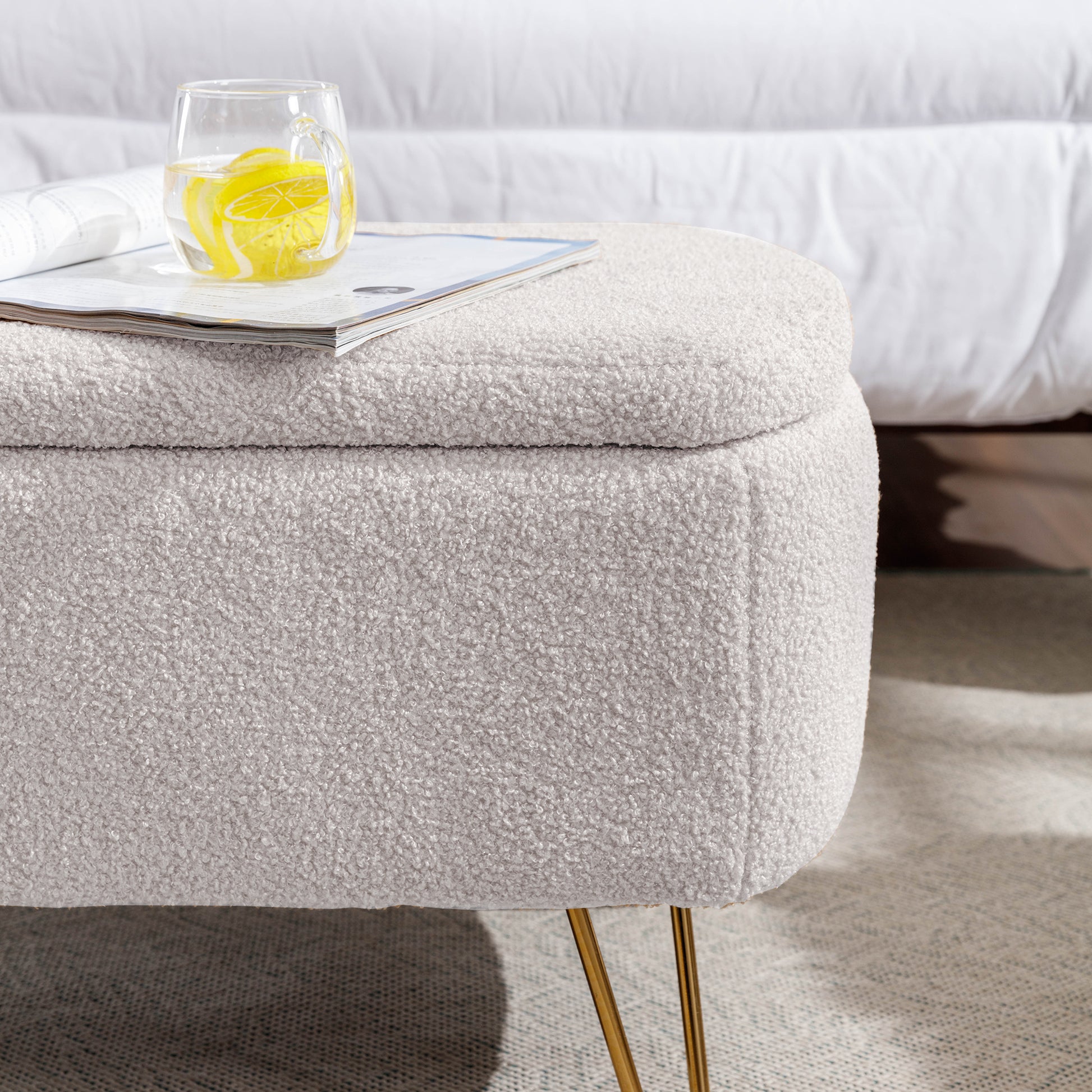 Cream boucle storage ottoman with gold hairpin legs