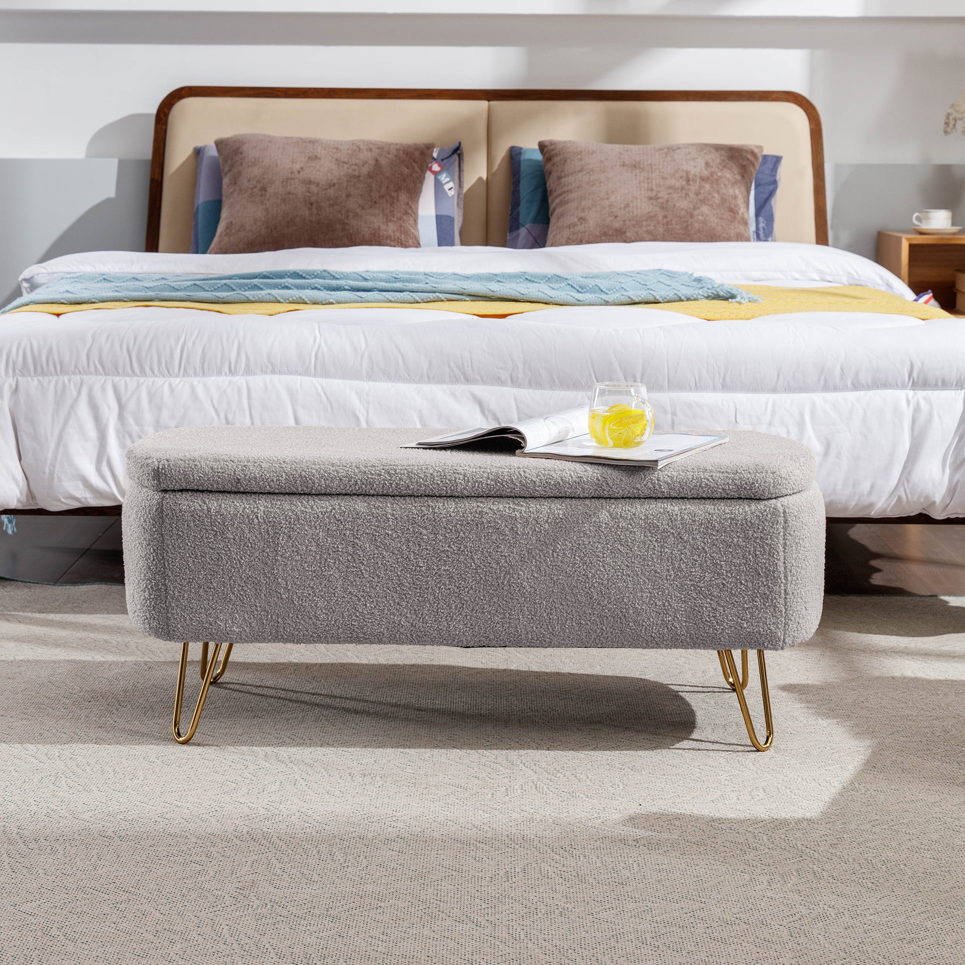 Gray boucle storage ottoman with gold hairpin legs ideal for bedroom footrest