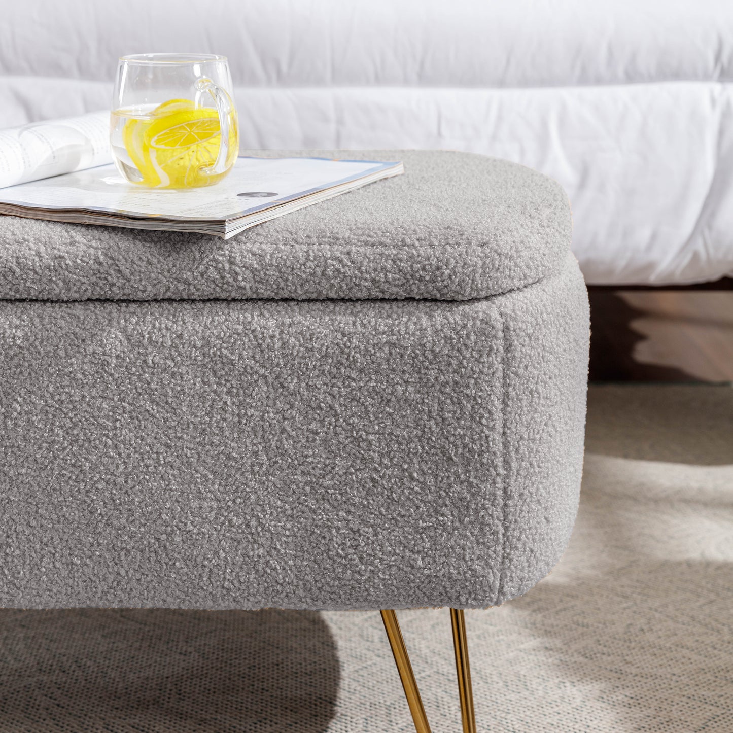 Gray boucle storage ottoman with gold hairpin legs