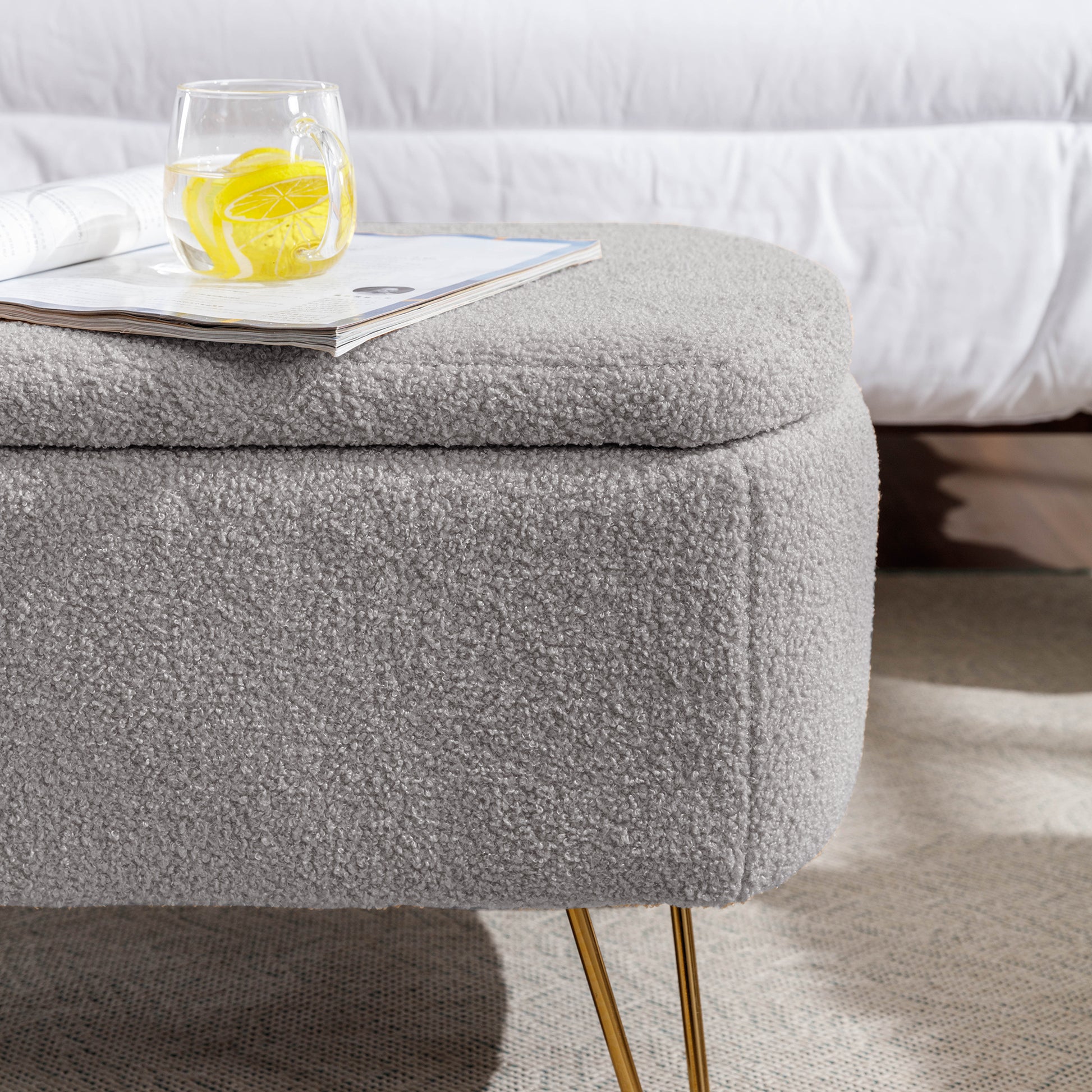 Gray boucle storage ottoman with gold hairpin legs