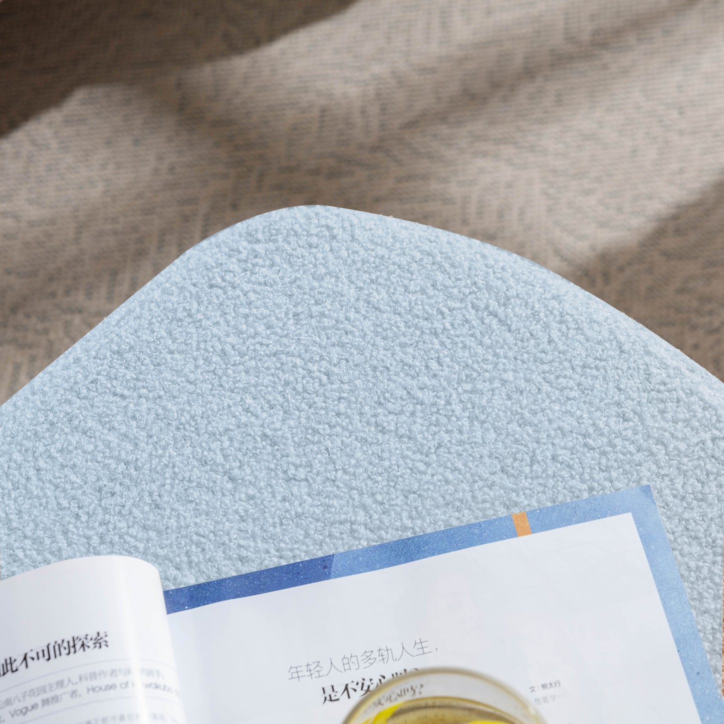 Light blue sherpa ottoman with textured fabric and soft pile