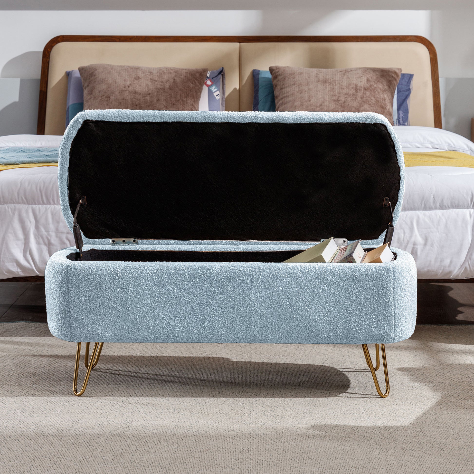 Light blue boucle storage ottoman with gold hairpin legs