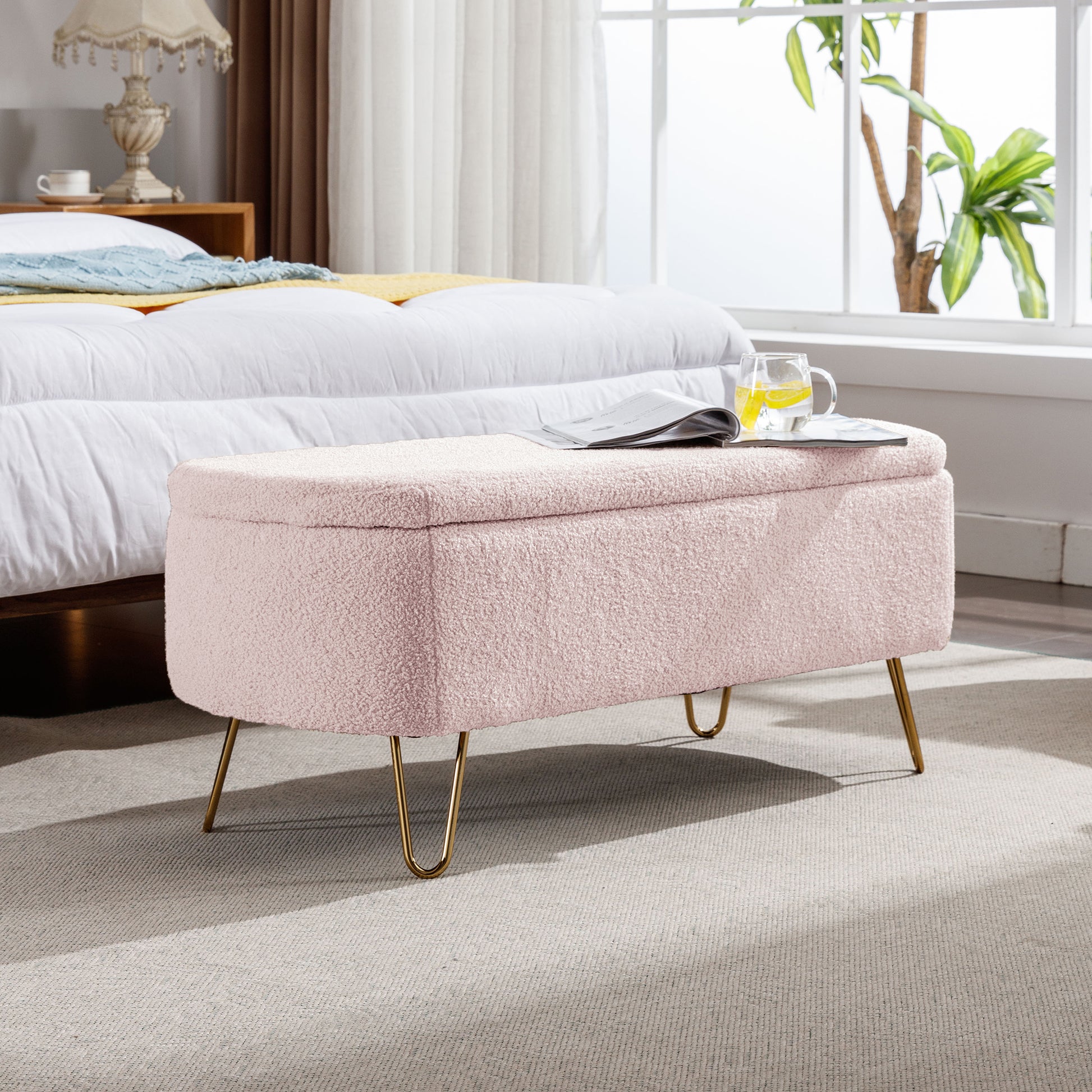 Soft pink teddy fabric storage ottoman with gold hairpin legs for bedroom use