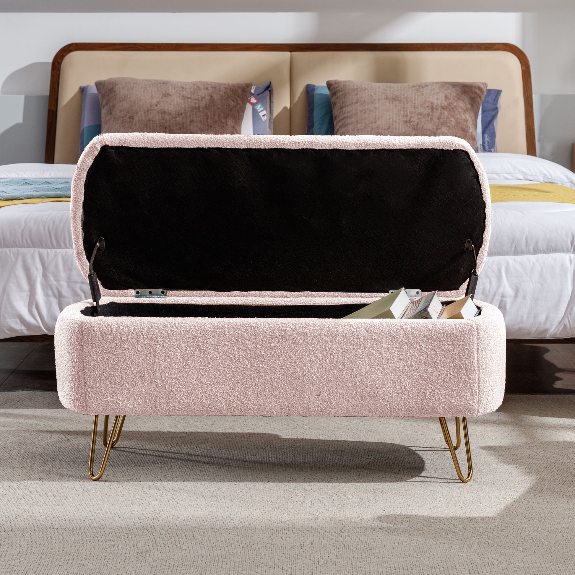 Pink sherpa storage bench with open lid revealing books