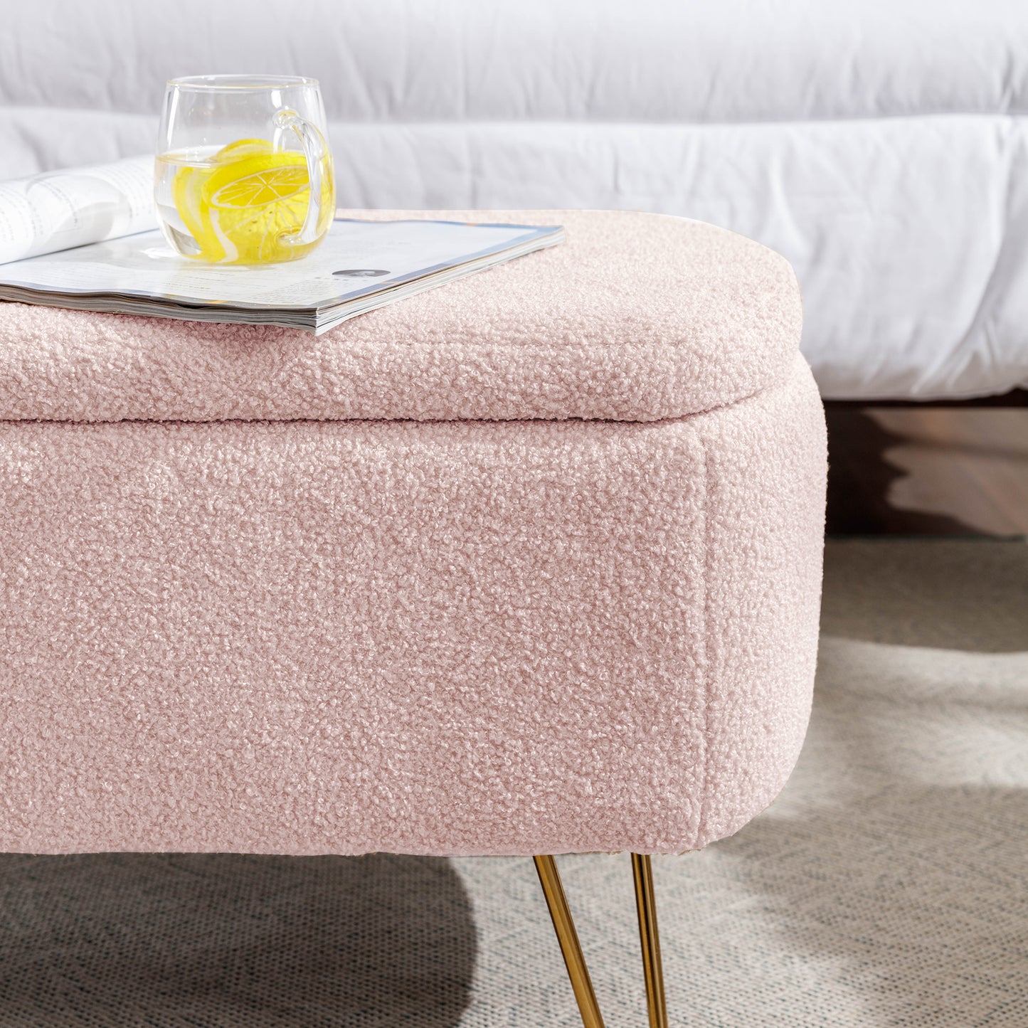 Pink boucle storage ottoman with gold hairpin legs