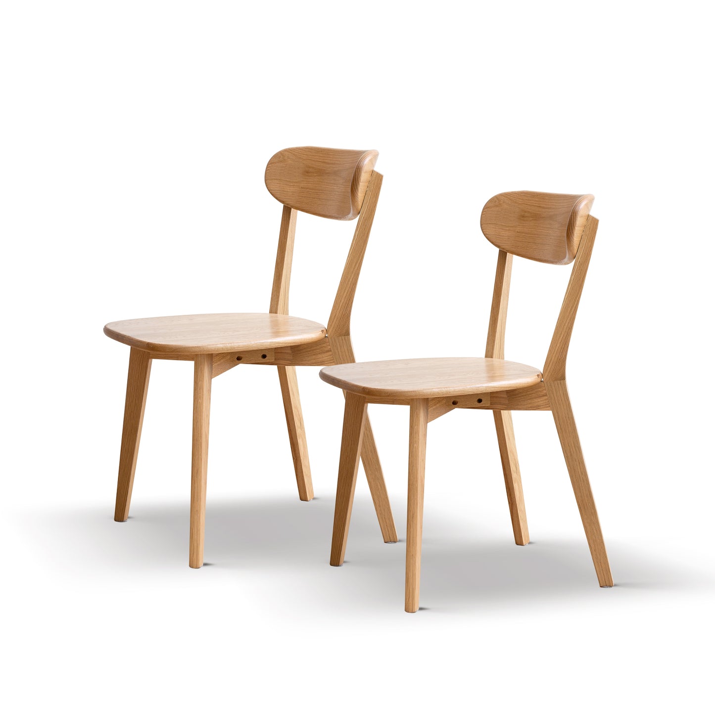 Two natural oak dining chairs with curved backrests