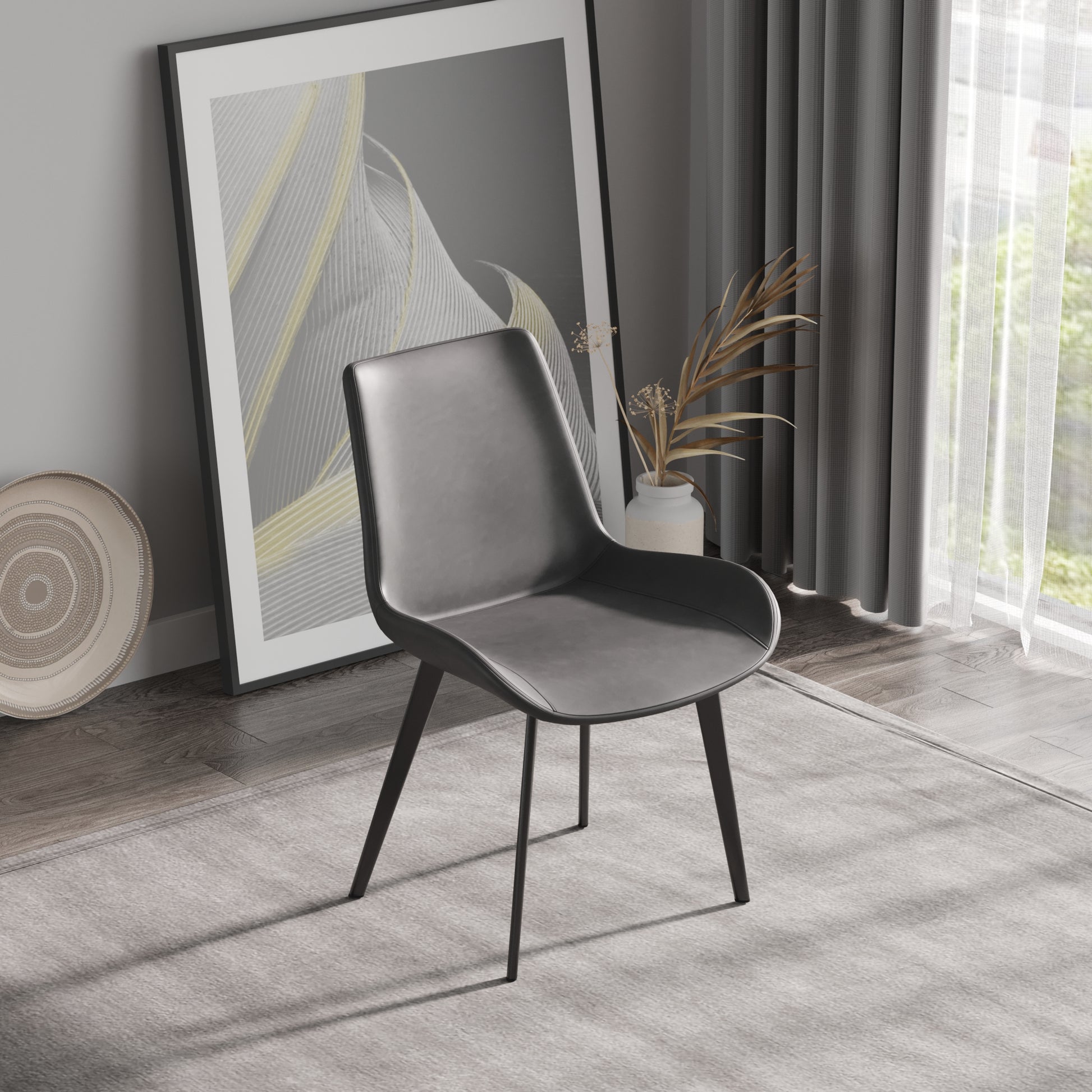 Modern grey faux leather dining chair with sleek black metal legs