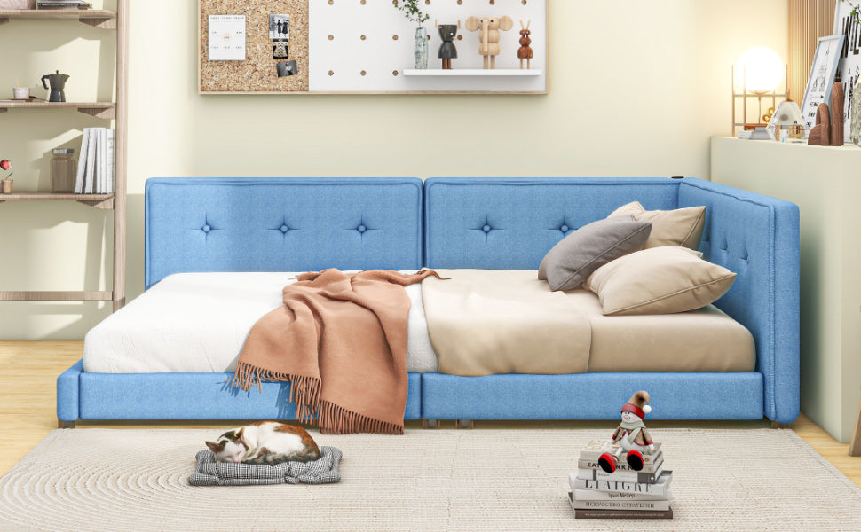 Blue upholstered twin daybed with tufted headboard and orange throw