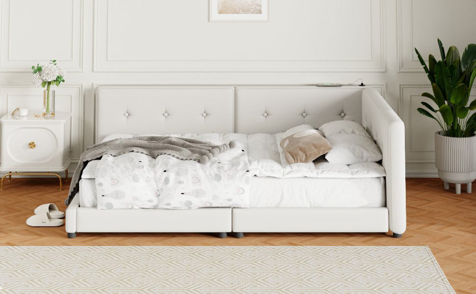 White tufted upholstered bed frame with twin mattresses and patterned duvet