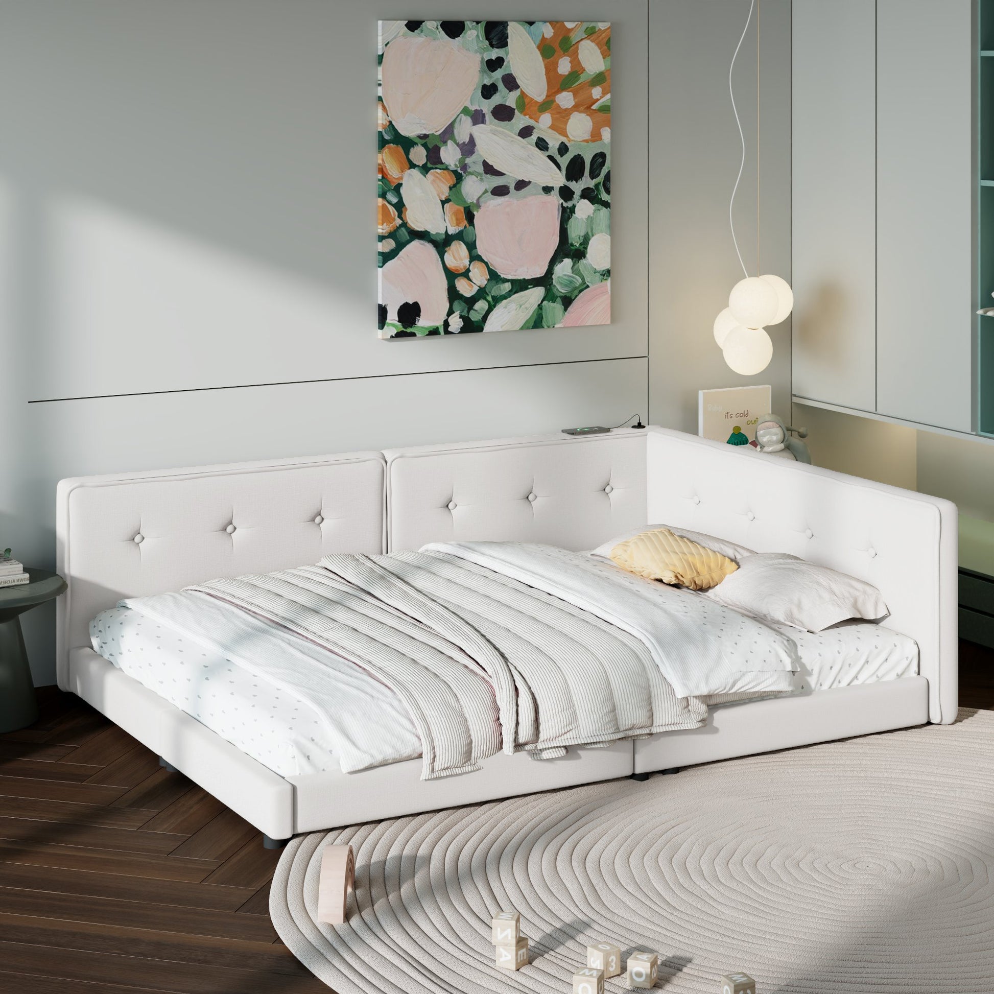 White tufted sectional daybed with plush bedding and decorative pillows