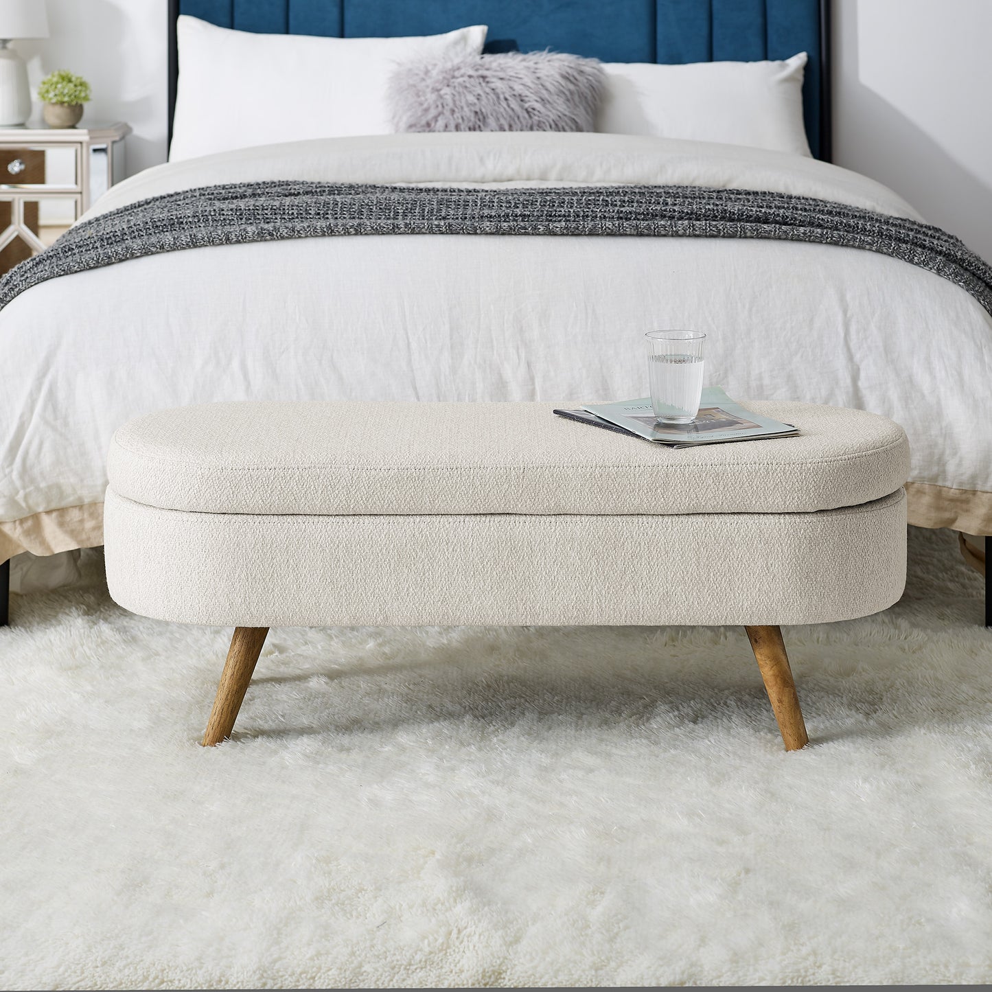 Cream textured storage ottoman with tapered wooden legs