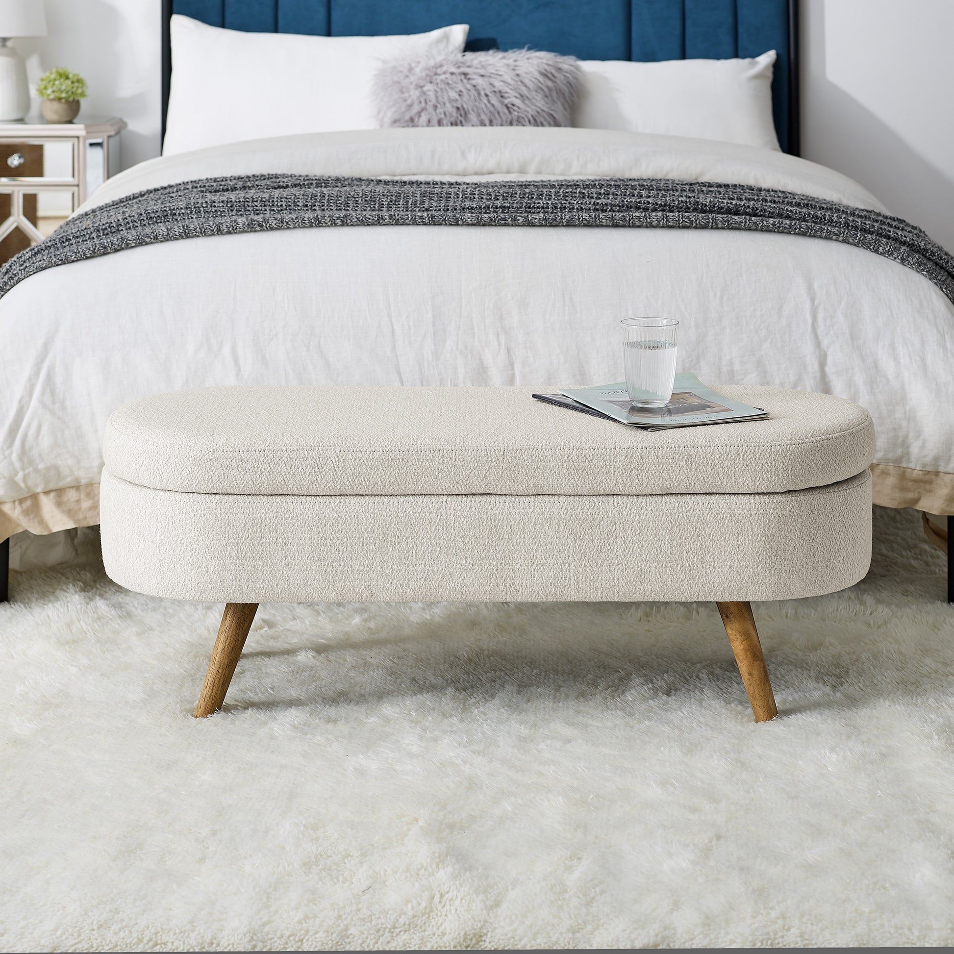 Cream textured storage ottoman with tapered wooden legs