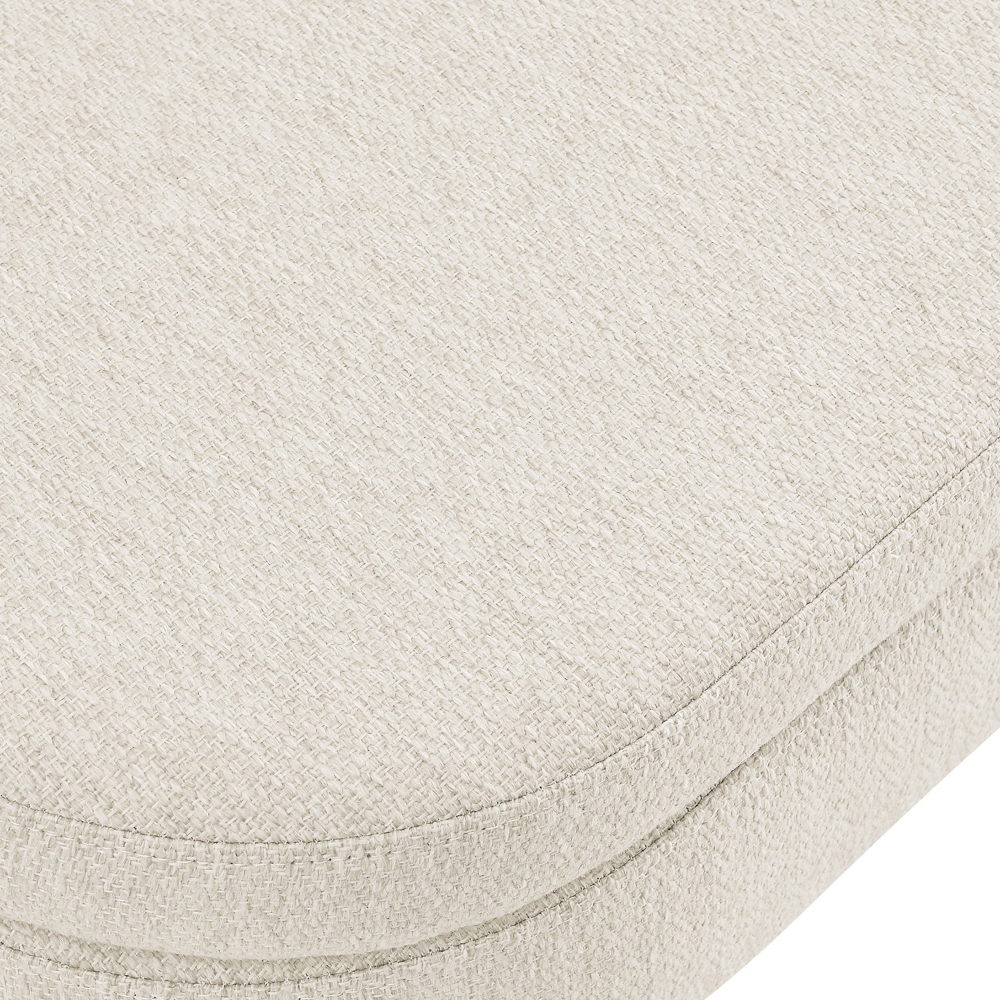 Cream textured fabric upholstery on a curved furniture cushion