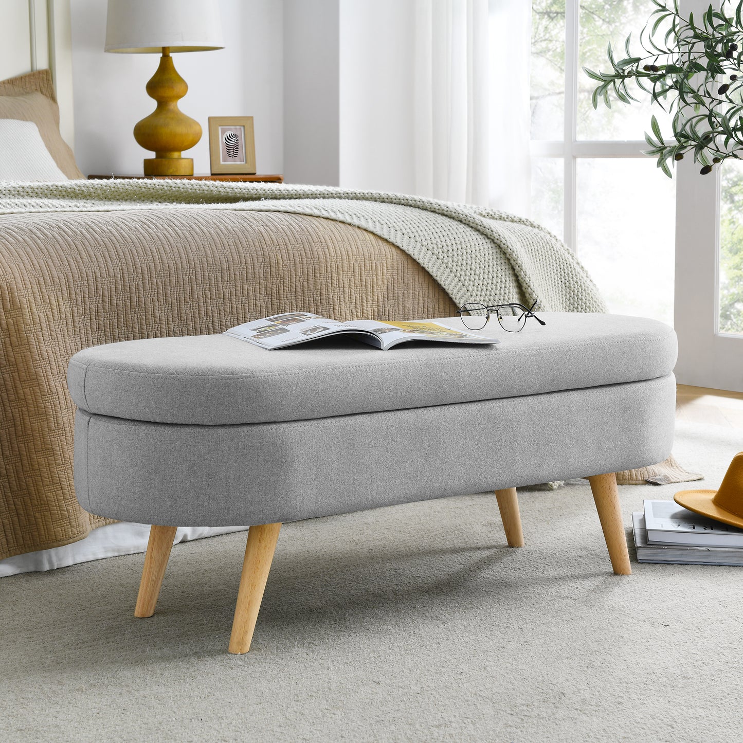 Grey upholstered storage bench with wooden legs ideal for bedroom organization