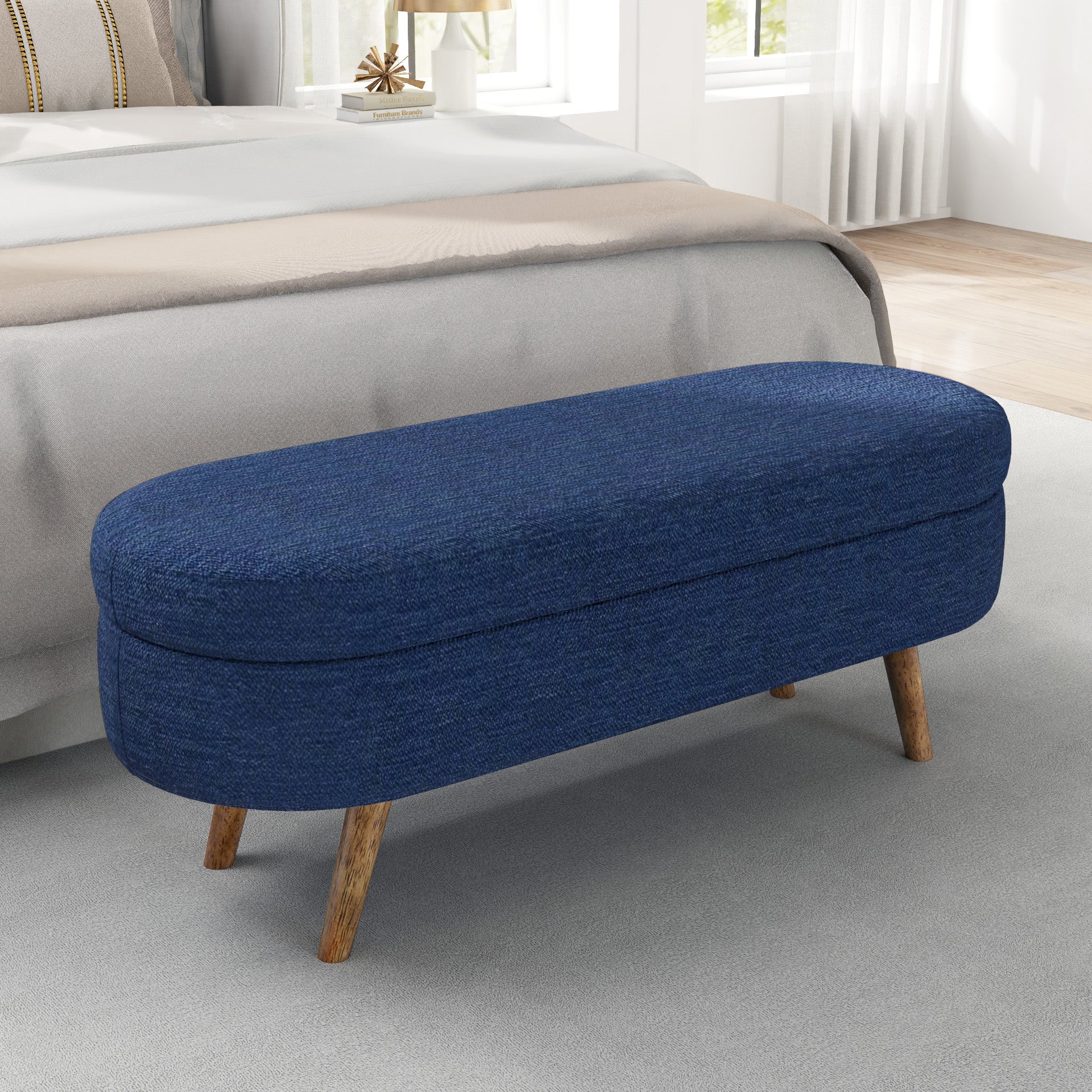 Oval navy upholstered storage bench with wooden legs