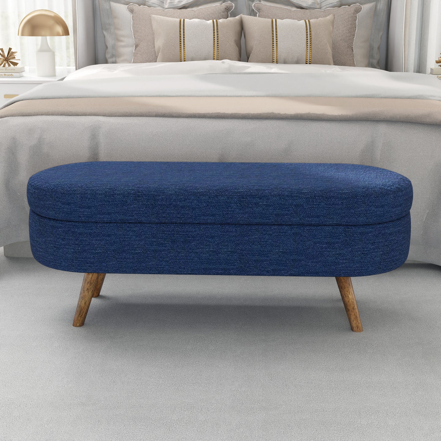 Blue upholstered storage ottoman with wooden tapered legs