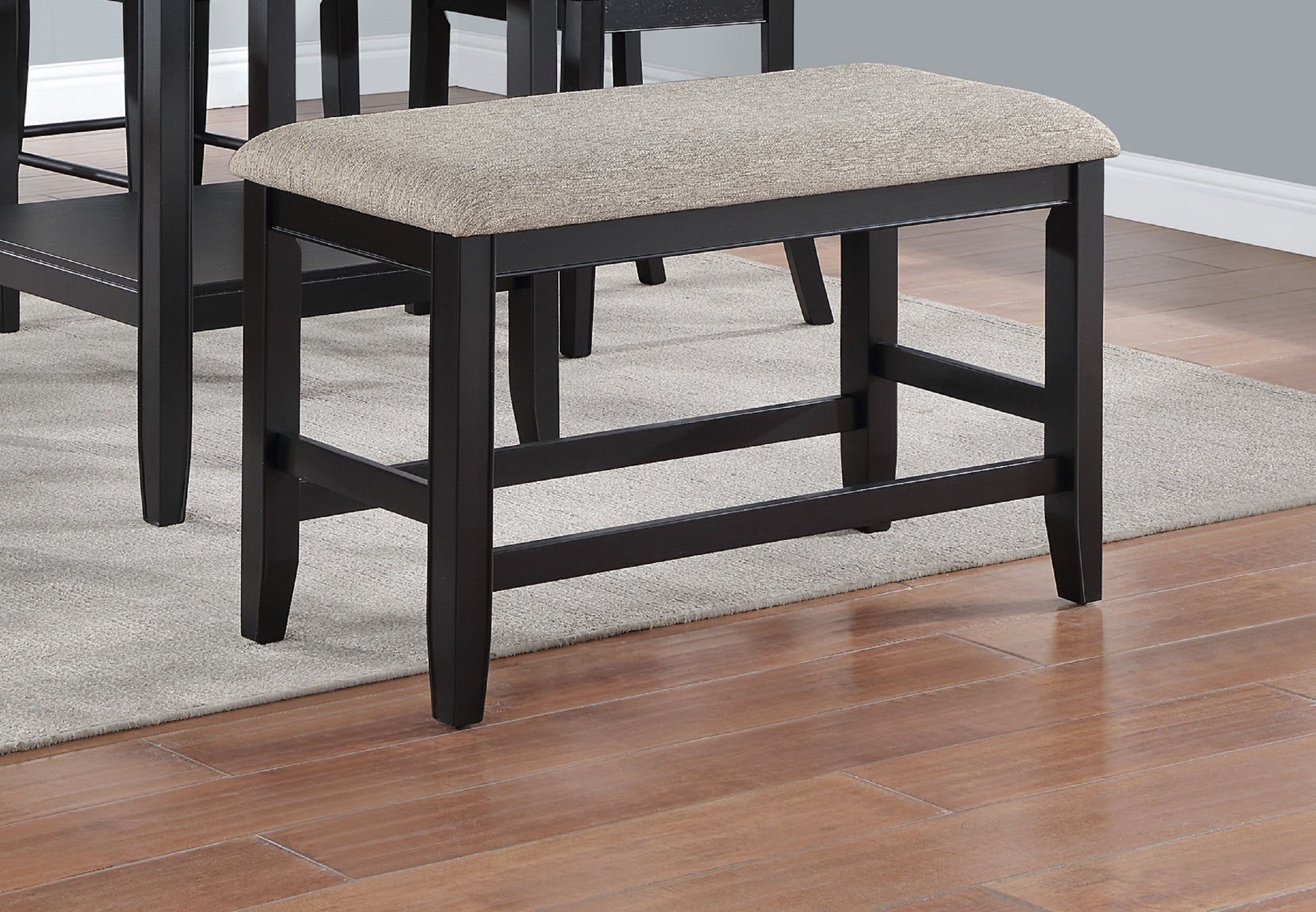 Dark wood counter stool with upholstered beige seat