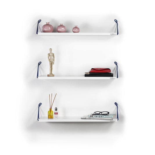 Pink ceramic pomegranate decorative objects on white shelf