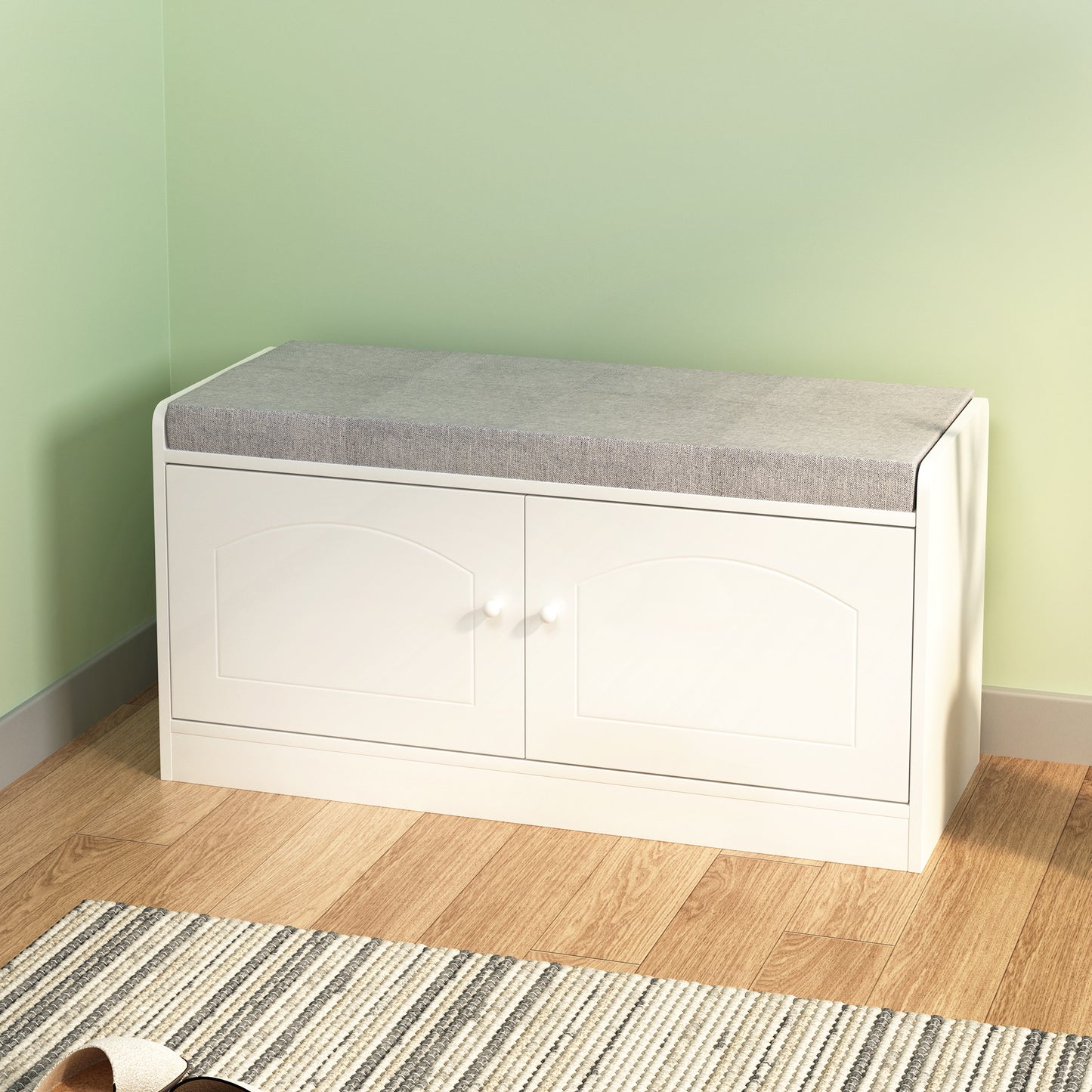 White storage bench with grey cushioned top and two arched doors