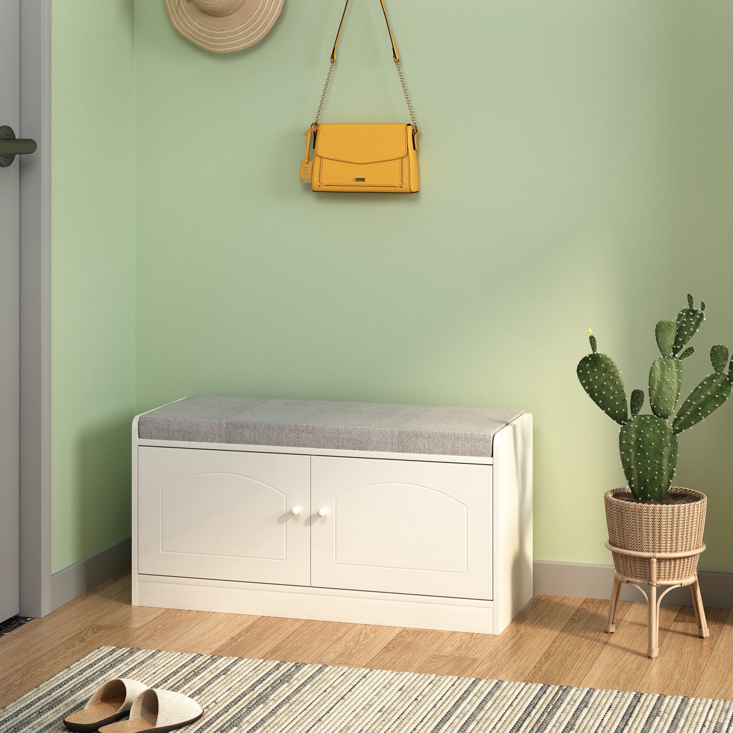 White storage bench with grey upholstered seat and dual cabinet doors