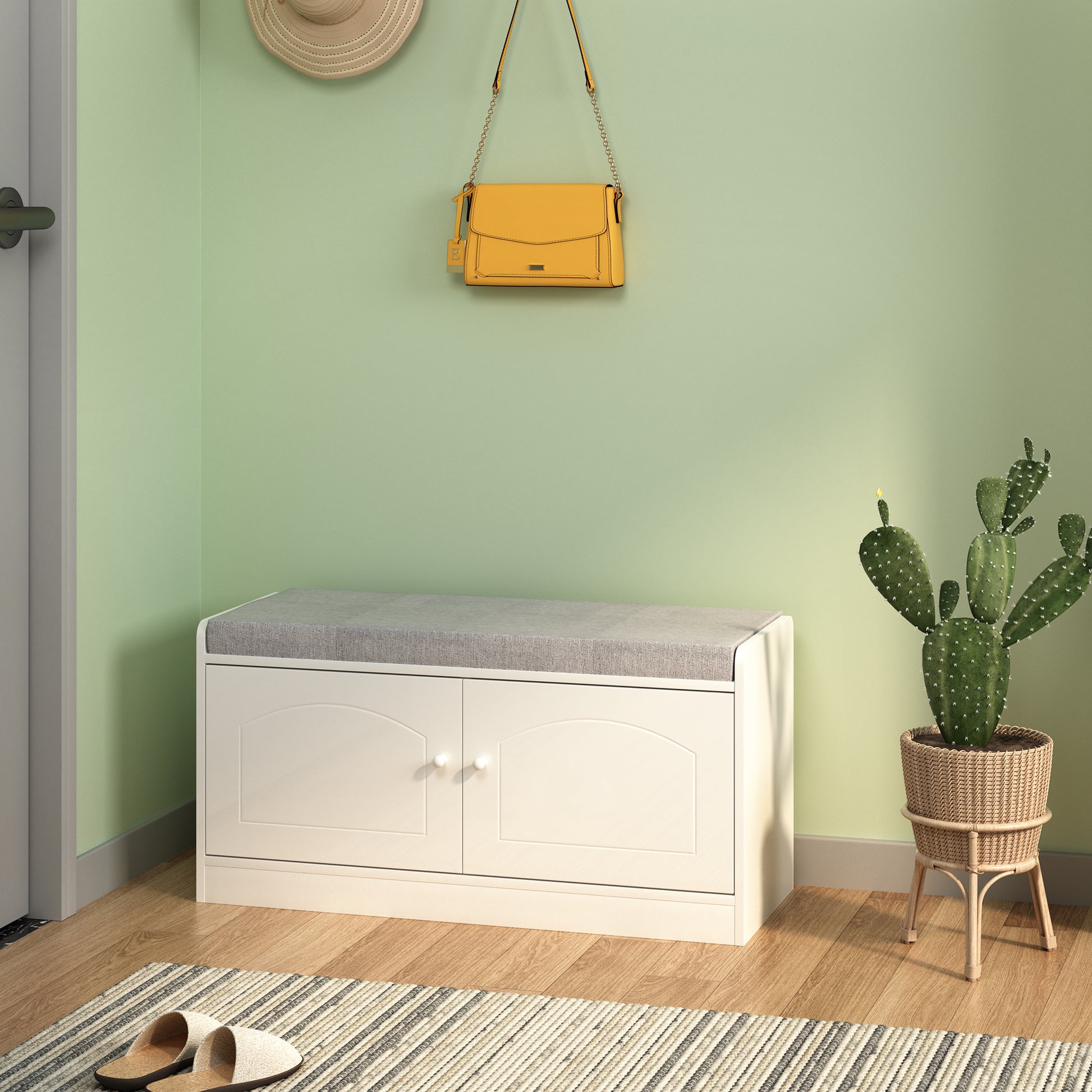 White storage bench with grey upholstered seat and dual cabinet doors