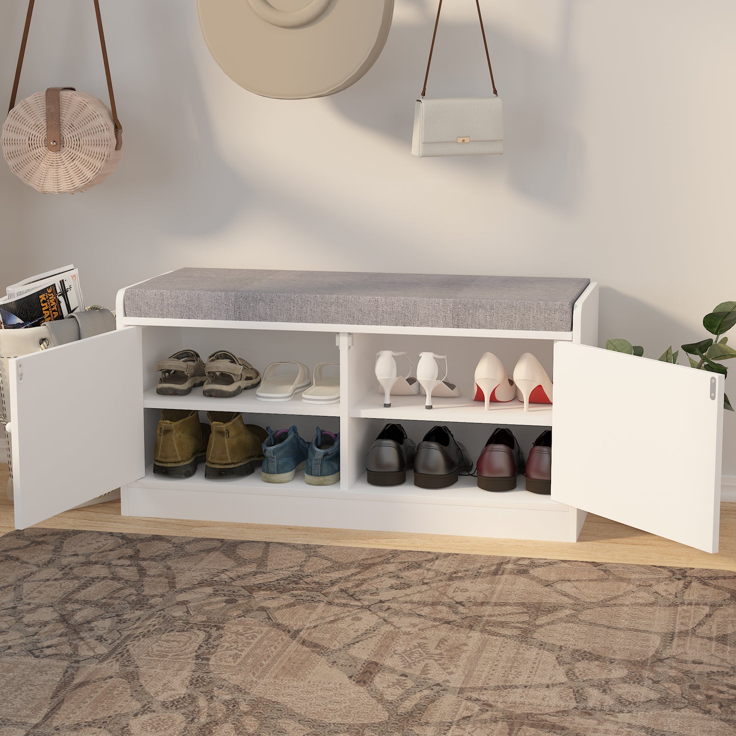 White shoe cabinet bench with gray upholstered top storing various shoes