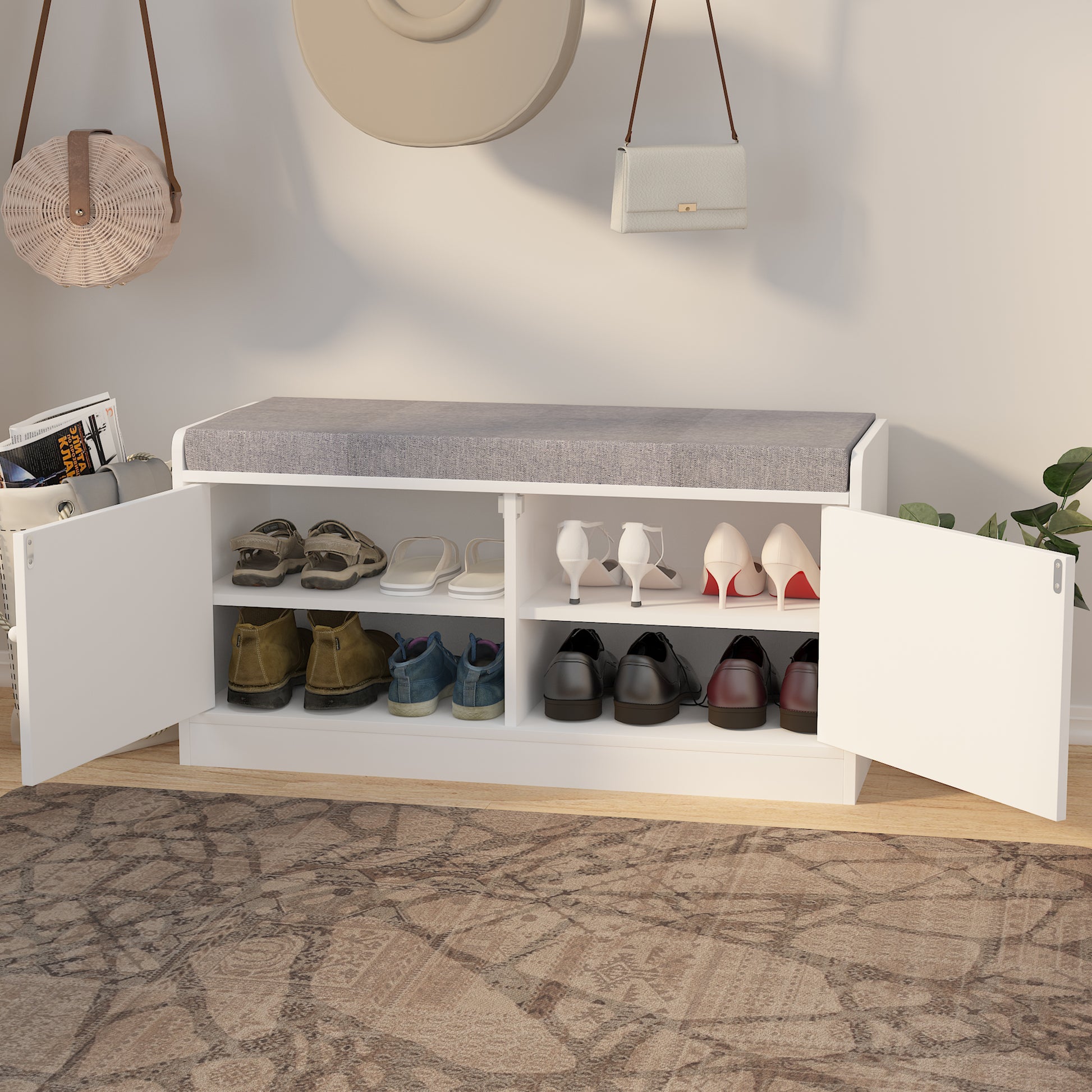 White shoe cabinet bench with gray upholstered top storing various shoes