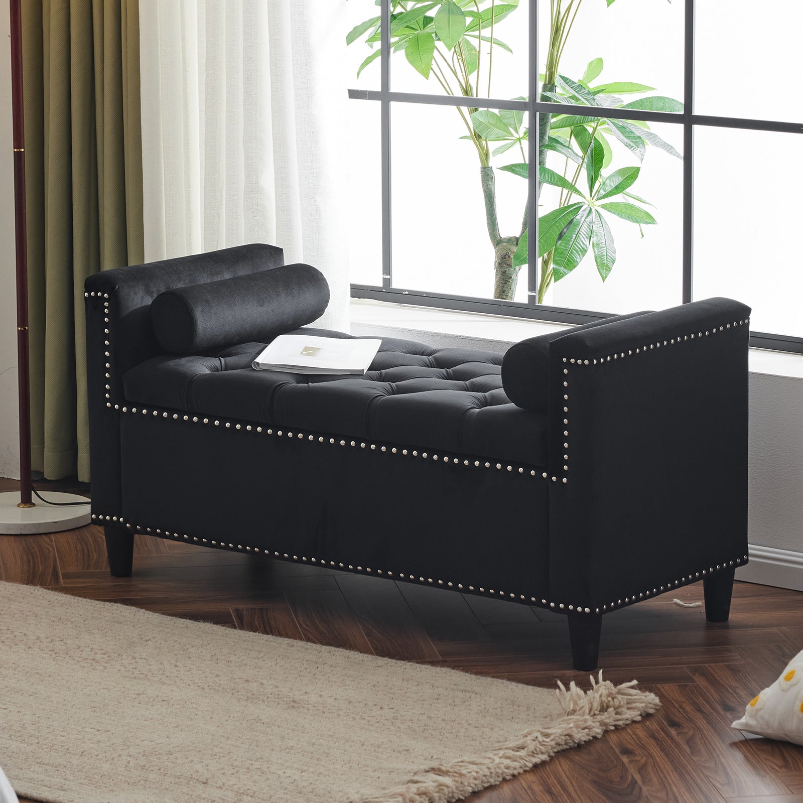 Black velvet storage bench with tufted top and silver nailhead trim