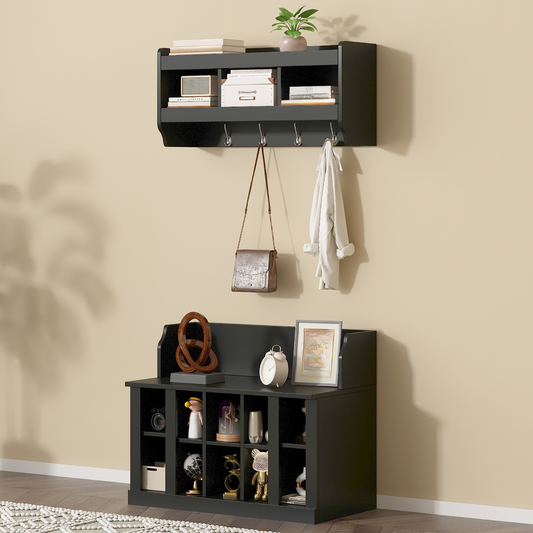 Black entryway wall shelf with hooks holding a brown crossbody bag and white jacket