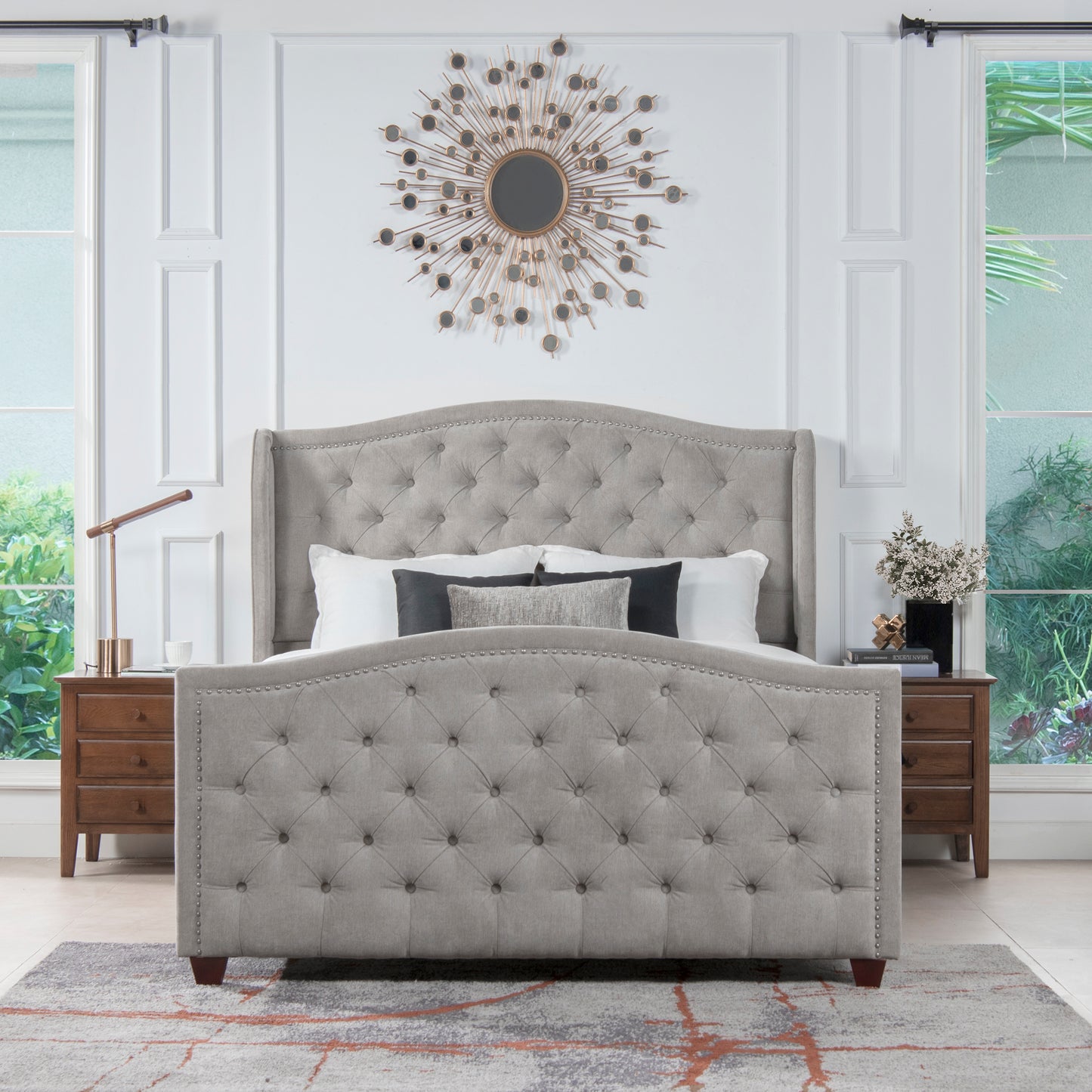 Gray fabric tufted king bed with nailhead trim