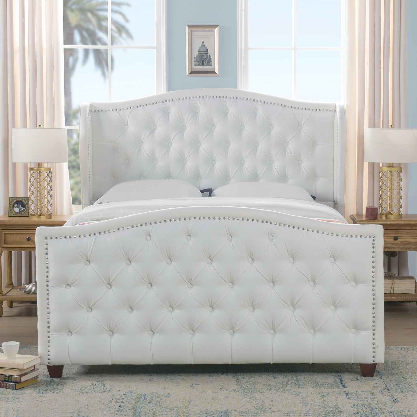White faux leather tufted wingback bed with silver nailhead trim