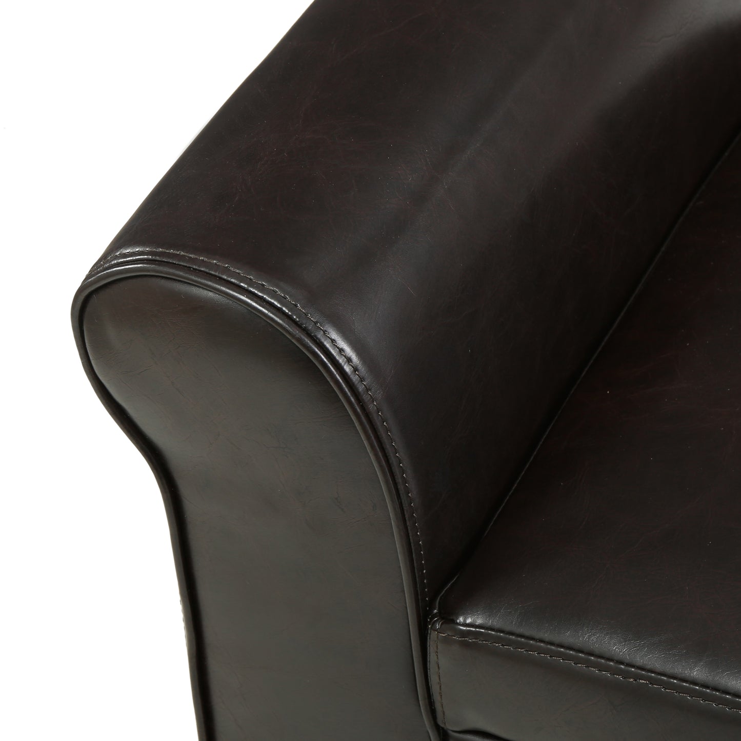Dark brown faux leather armchair armrest with detailed stitching