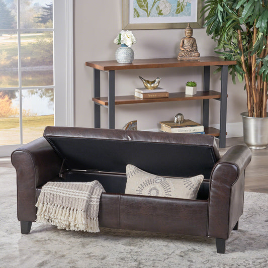 Dark brown faux leather storage ottoman bench with rolled arms and fringed throw