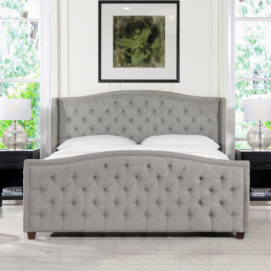 Grey tufted wingback bed with nailhead trim