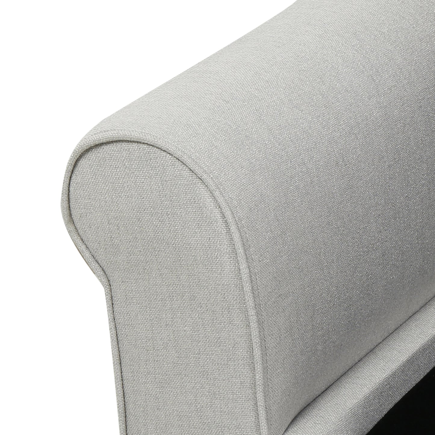 Closeup of textured light grey fabric on a sofa armrest