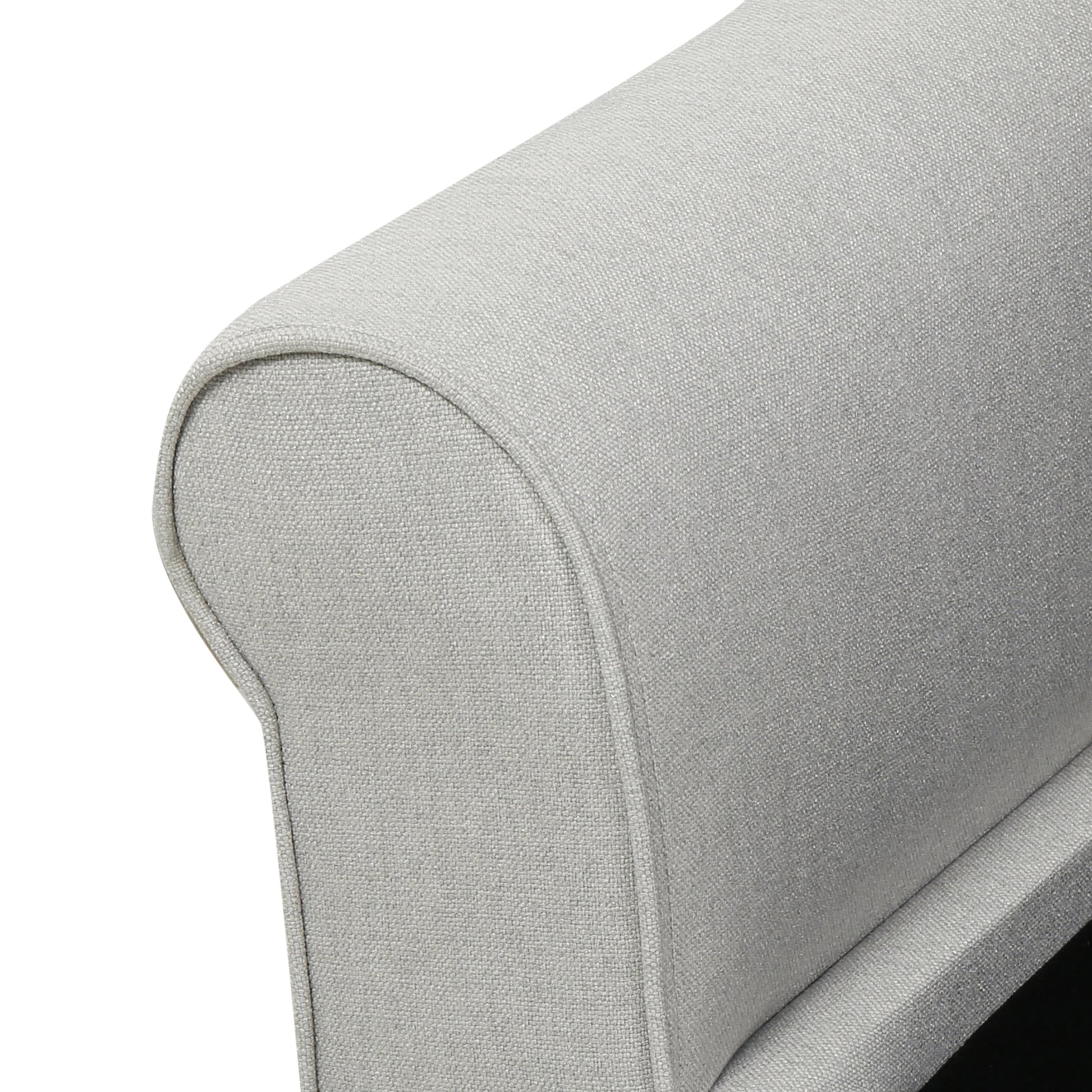 Closeup of textured light grey fabric on a sofa armrest